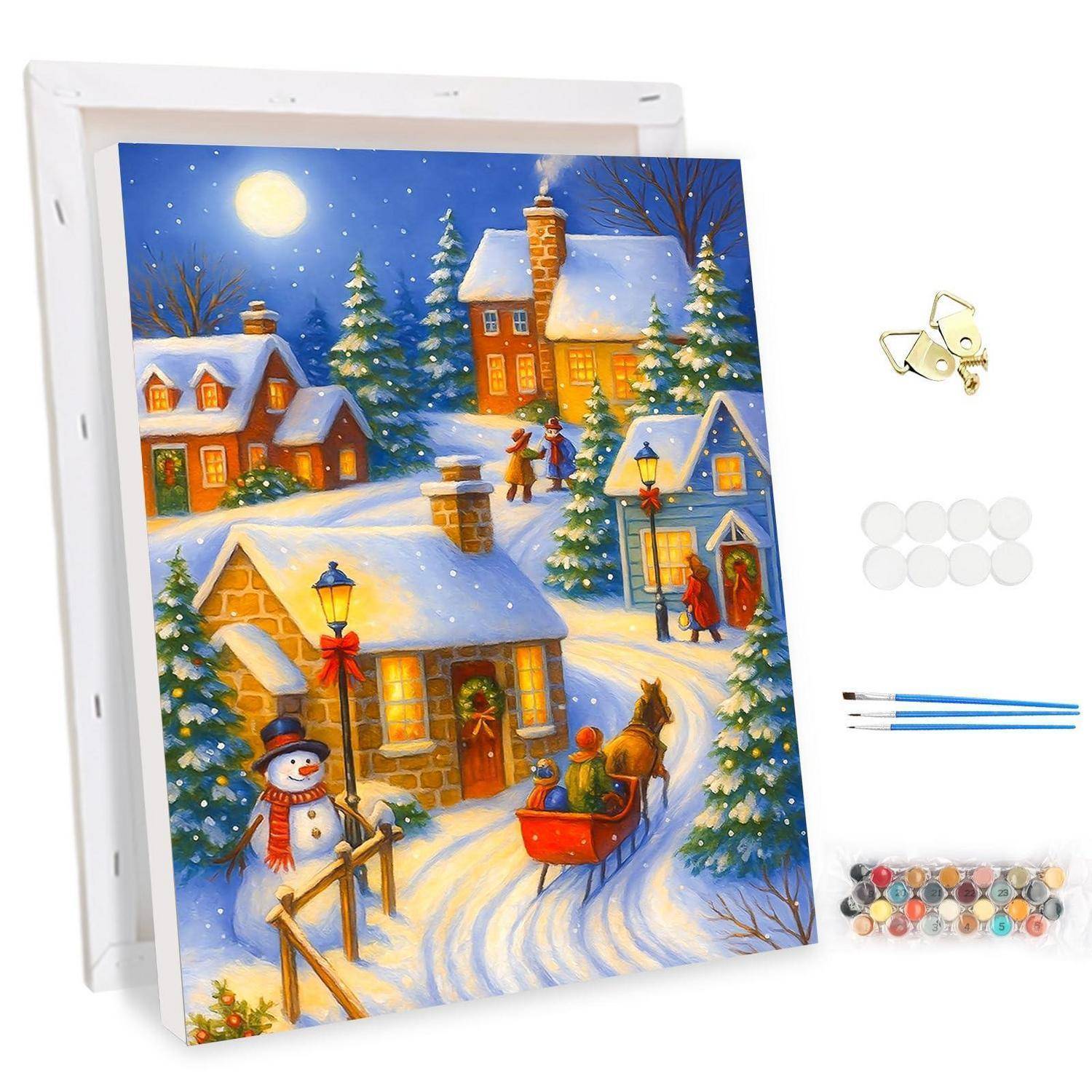 Malset für winterliches Schneedorf mit Leinwand, Farben, Pinseln und Aufhängehardware; bunte Häuser, Bäume, Schneemann und Schlittenszene.