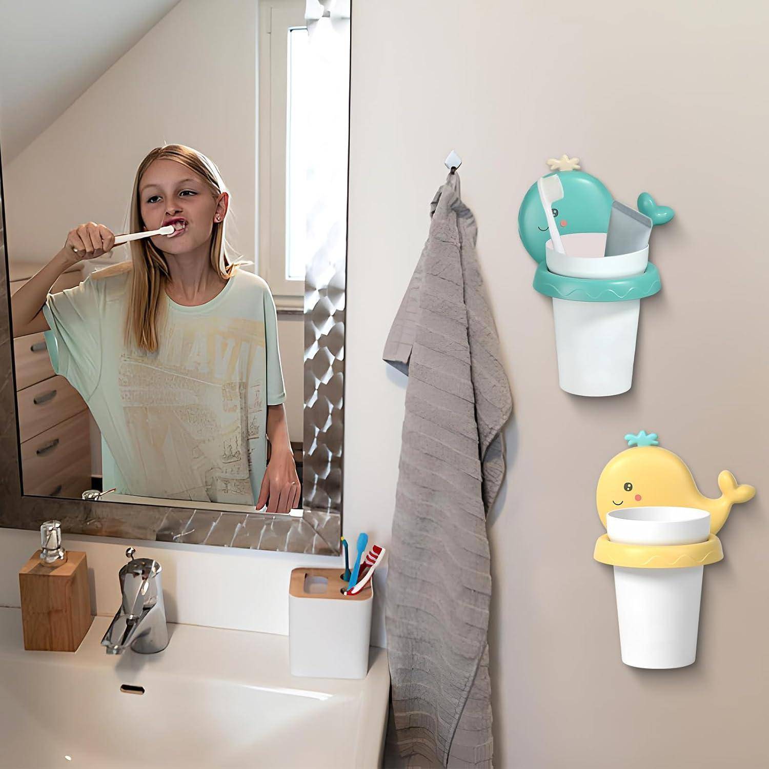 Mädchen putzt sich die Zähne an einem Waschbecken im Badezimmer, mit Zahnbürsenhaltern und einem Handtuch an der Wand in der Nähe.