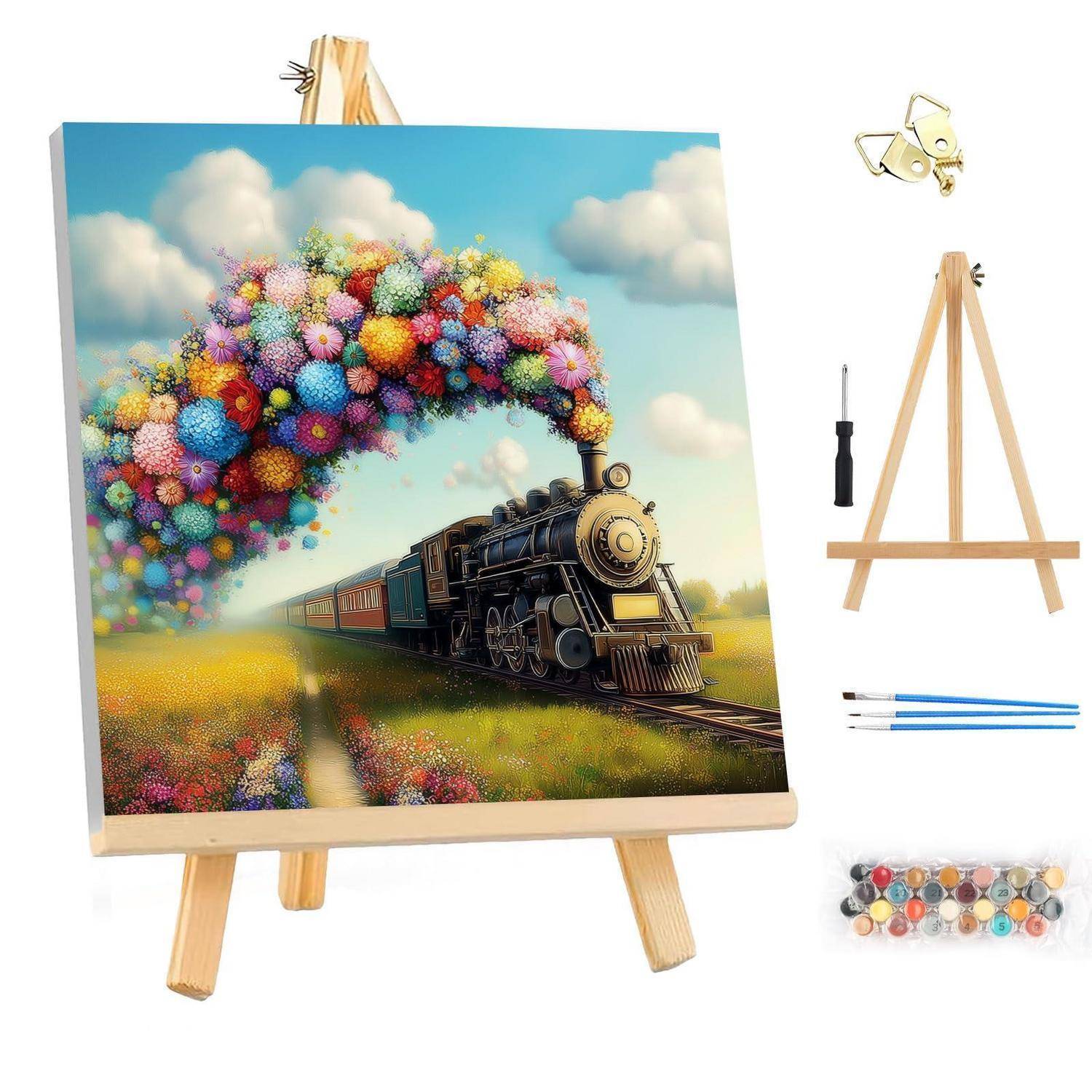 Mini-Staffelei-Display mit einem farbenfrohen Gemälde einer Dampflok, die eine Regenbogensäule aus Blumen ausstößt, mit daneben gezeigten Kunstwerkzeugen.