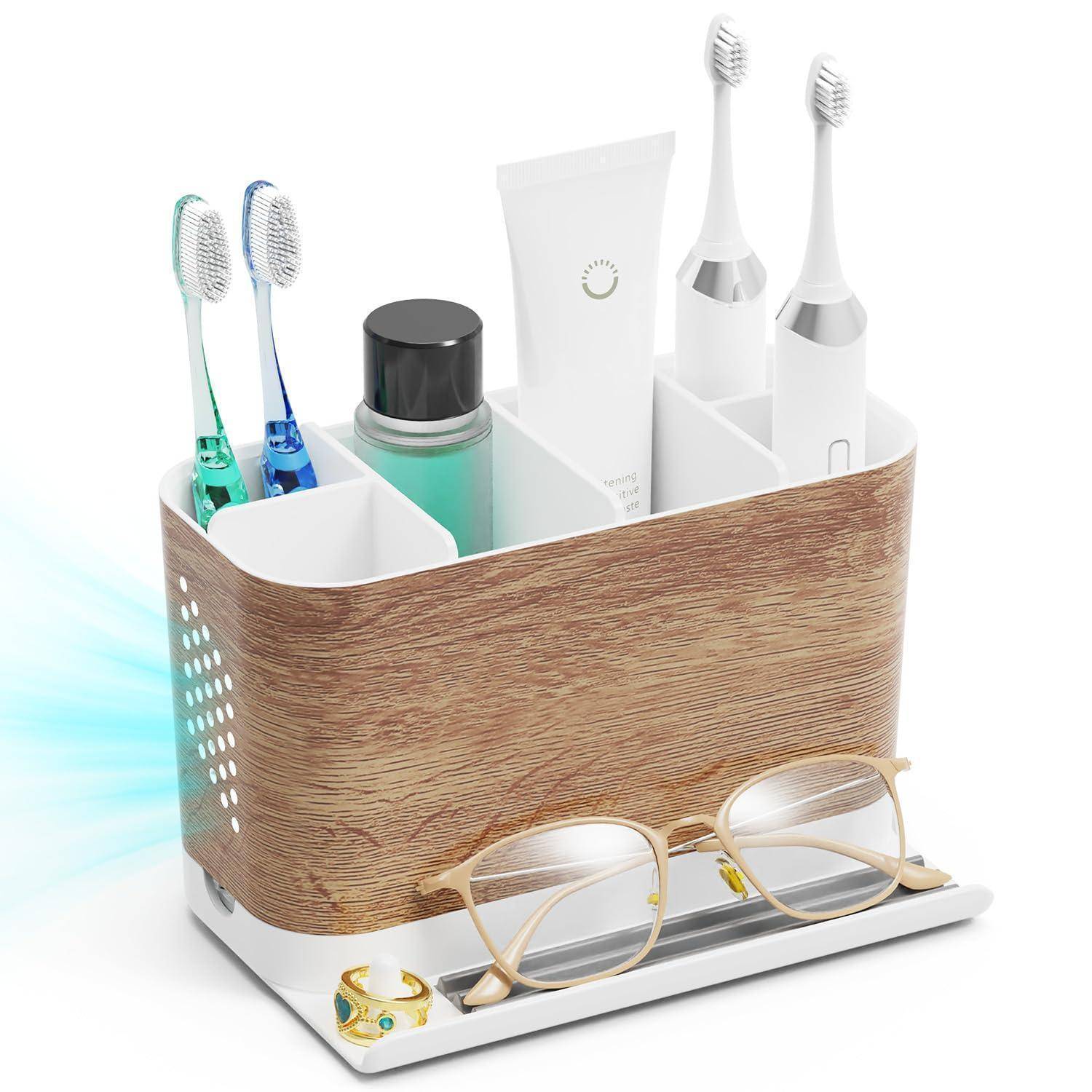Badezimmer-Arbeitsflächenorganizer mit Fächern zum Aufbewahren von Zahnbürsten, Zahnpasta, Mundwasser und Brillen auf einer weißen Basis.