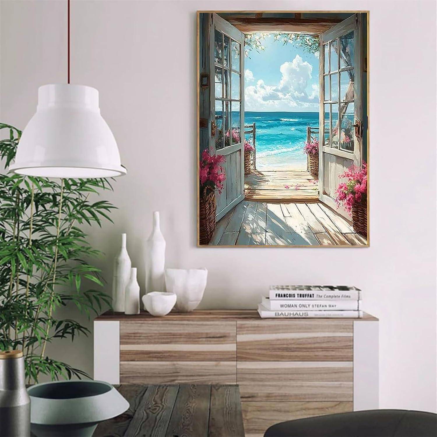 Gerahmtes Küstengemälde über einem Holz-Sideboard, mit einer offenen Tür zu einer hellen Meerblick in einem modernen Wohnzimmer.