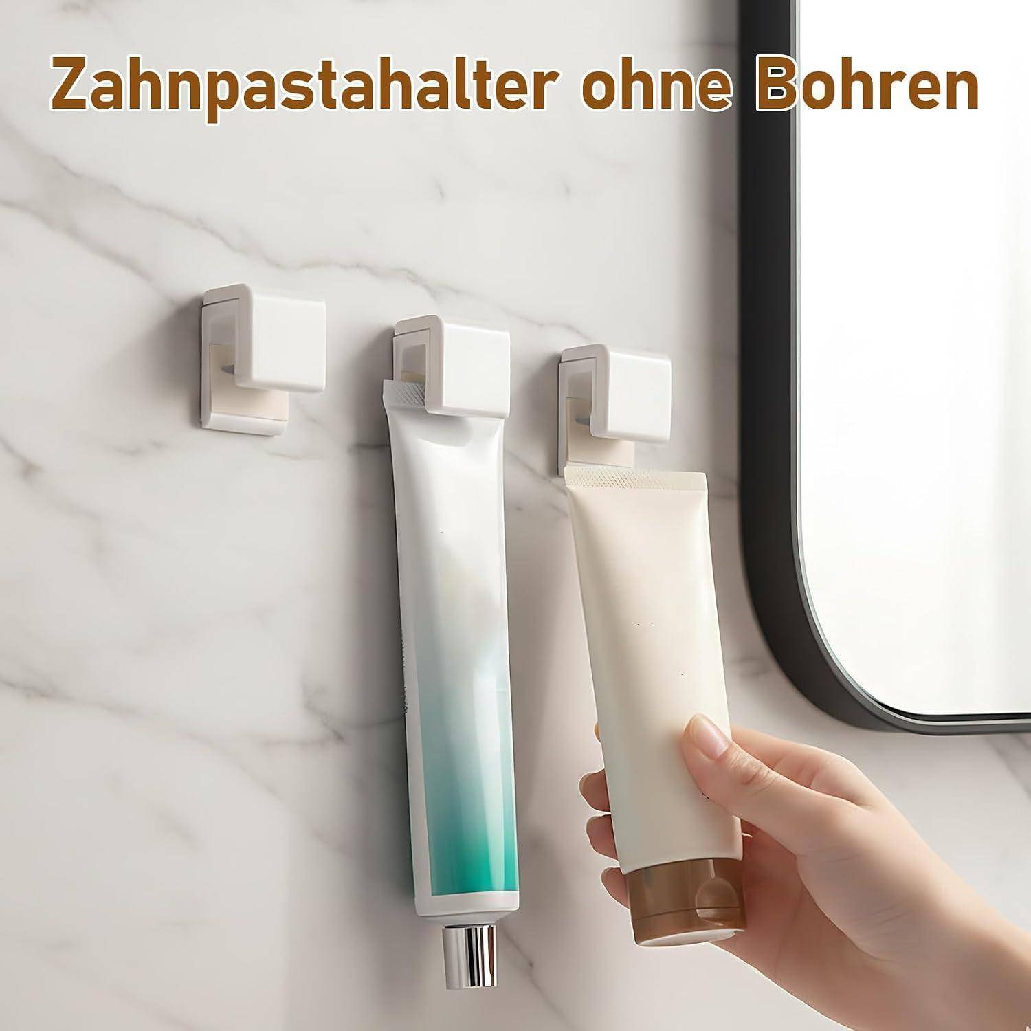 Drei an einer Marmorbadezimmerwand montierte Zahnpastahalter, mit einer Hand, die eine Tube in einen einsetzt; der Text lautet „Zahnpastahalter ohne Bohren