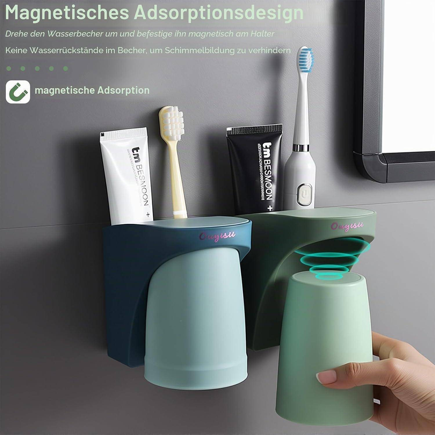 Magnetischer Badezimmer-Becherhalter mit umgestülpten Bechern, Zahnbürsten und Zahnpasta; ein Becher wird gerade angebracht, um das Magnetdesign zu demonstrieren.