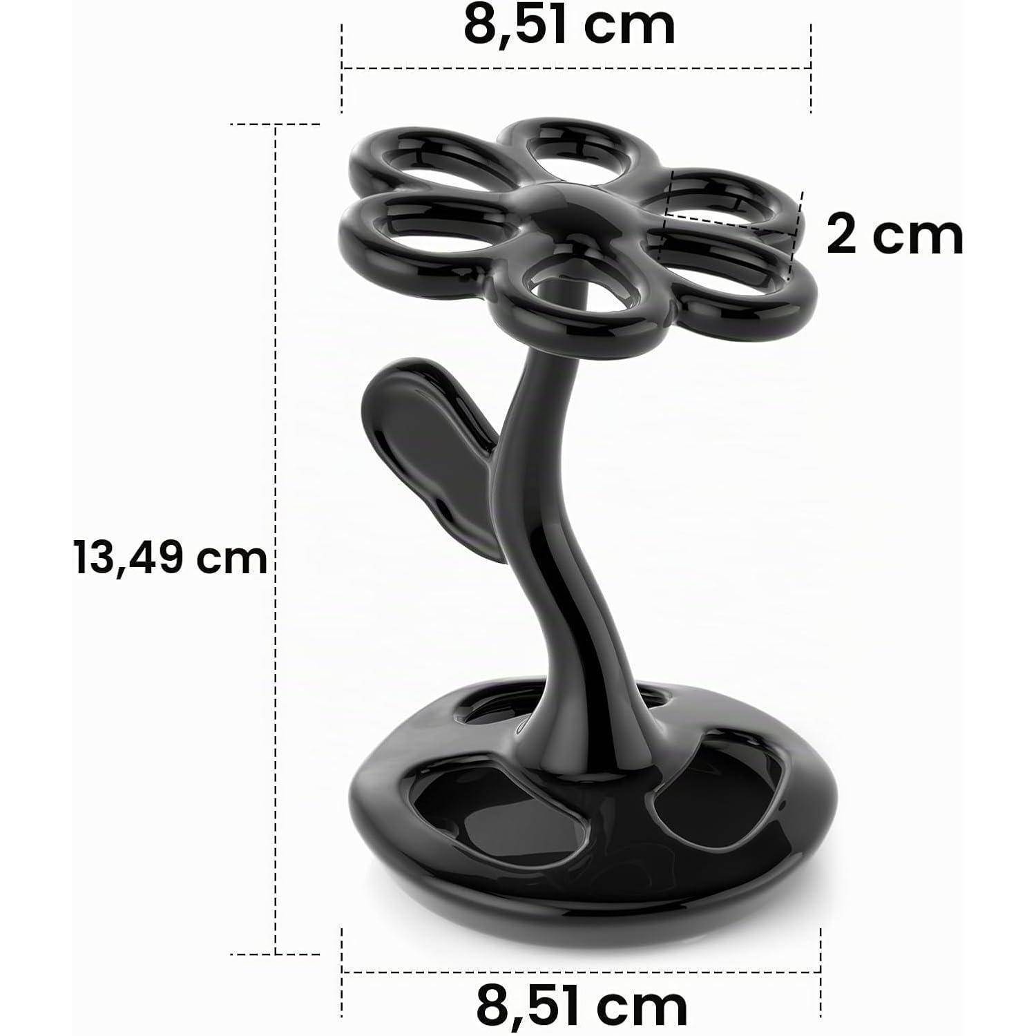 Schwarzer blütenförmiger Ständer mit sechs abgerundeten Schleifen auf einer glänzenden Basis; beschriftete Maße zeigen eine Höhe von 13,49 cm und eine Breite von 8,51 cm, mit einer Oberbreite von 2 cm.