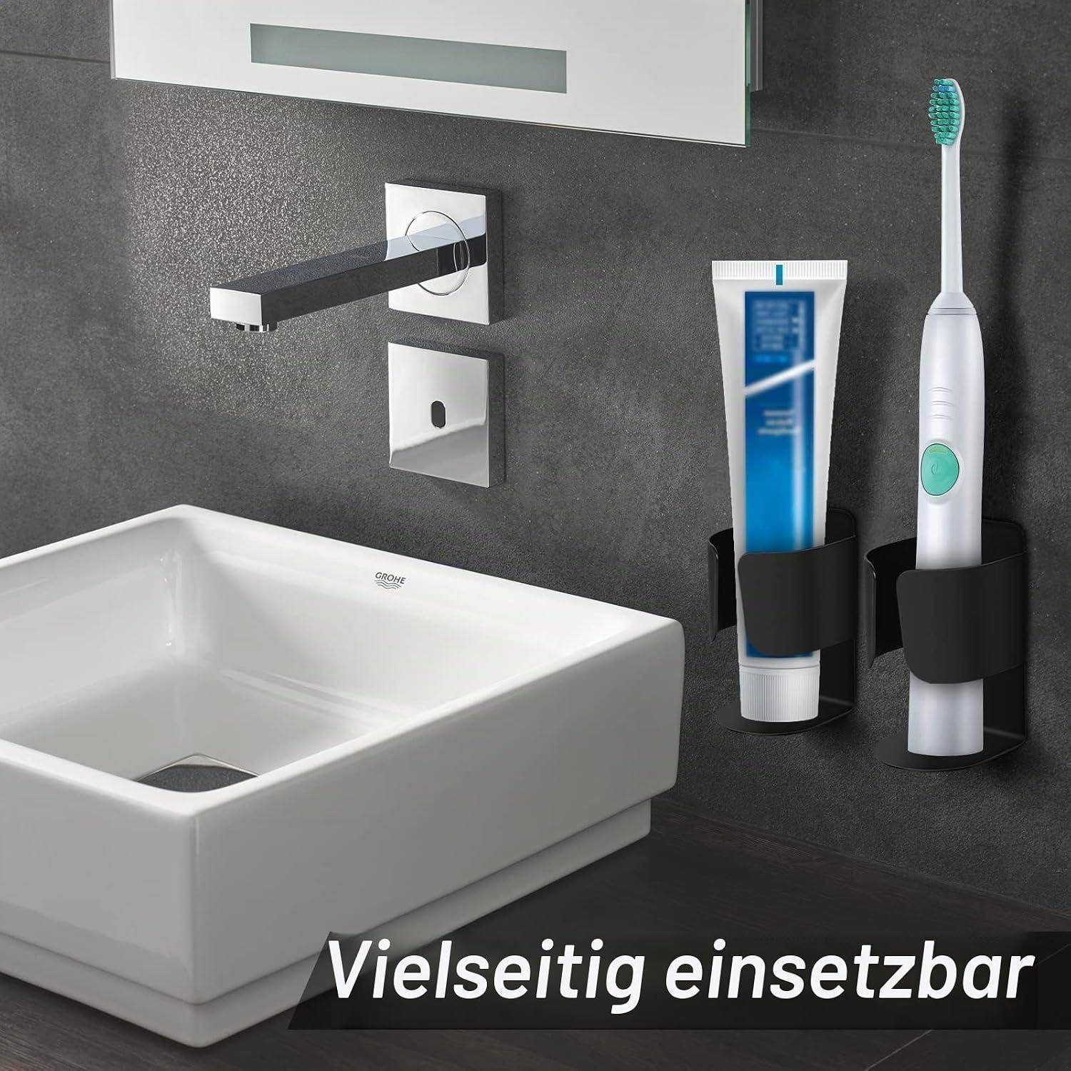 Badezimmerspüle mit wandmontiertem Wasserhahn und Haltern, plus eine Zahnbürste und Zahnpasta in schwarzen wandmontierten Spendern. Der Text lautet „Vielseitig einsetzbar