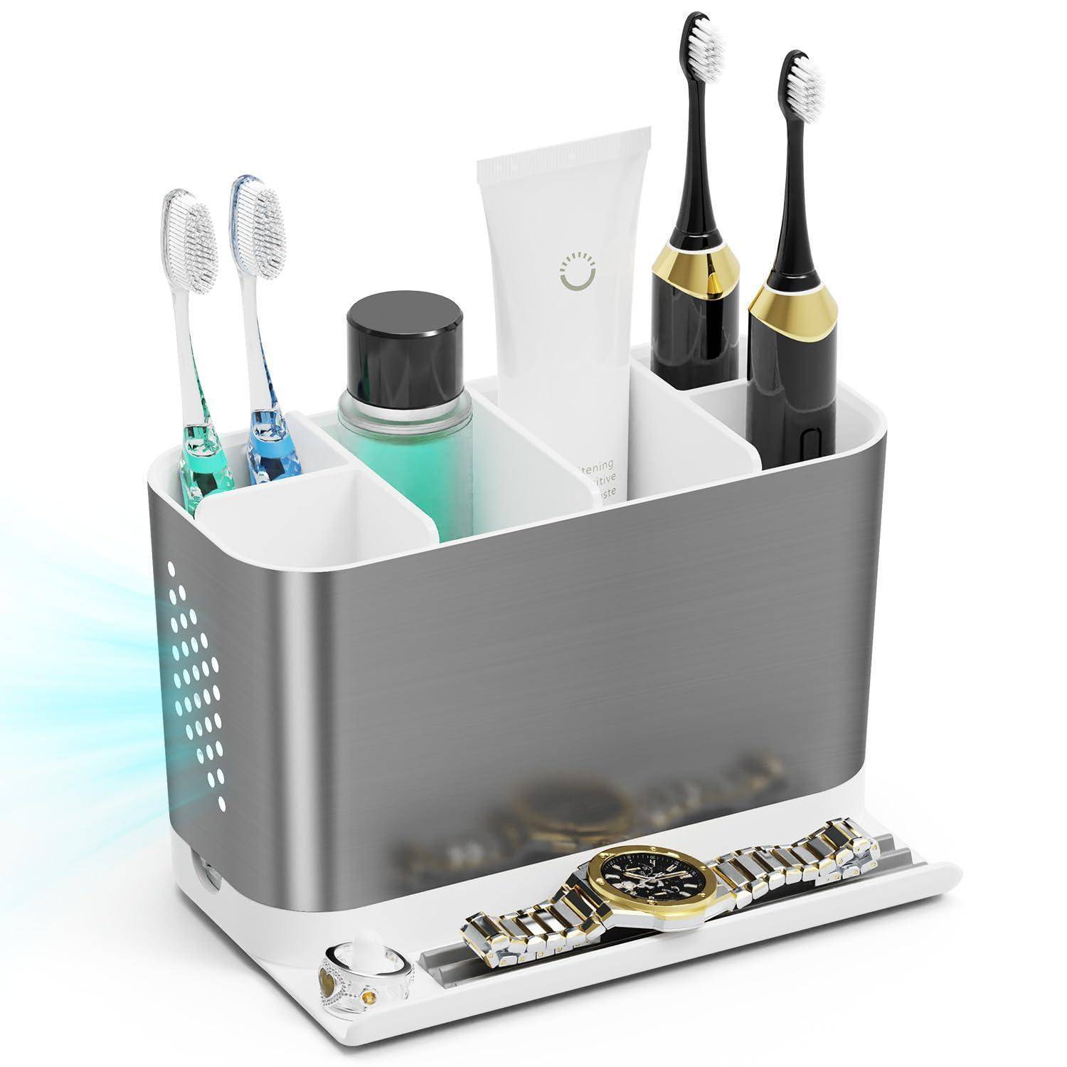 Badezimmer-Arbeitsplatte-Organizer, der elektrische Zahnbürsten, Zahnpasta, ein Glas und ein Uhrenablage-Tablett hält.