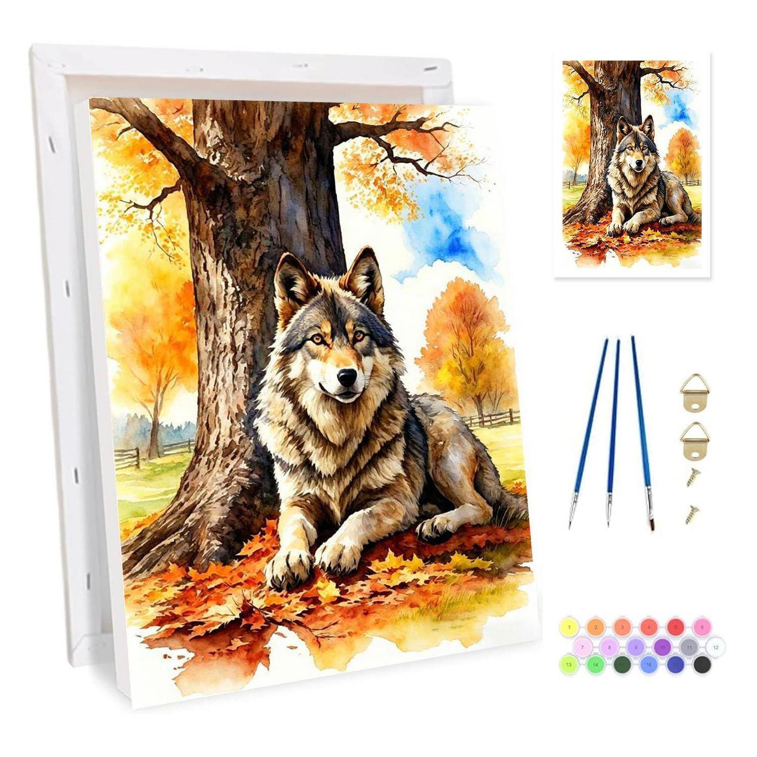 Malbuch-Set mit einem ruhenden Wolf neben einem Baum im Herbst, zeigt die Leinwand, Referenzbild, Pinsel, Aufhängehaken und Farbdosen.