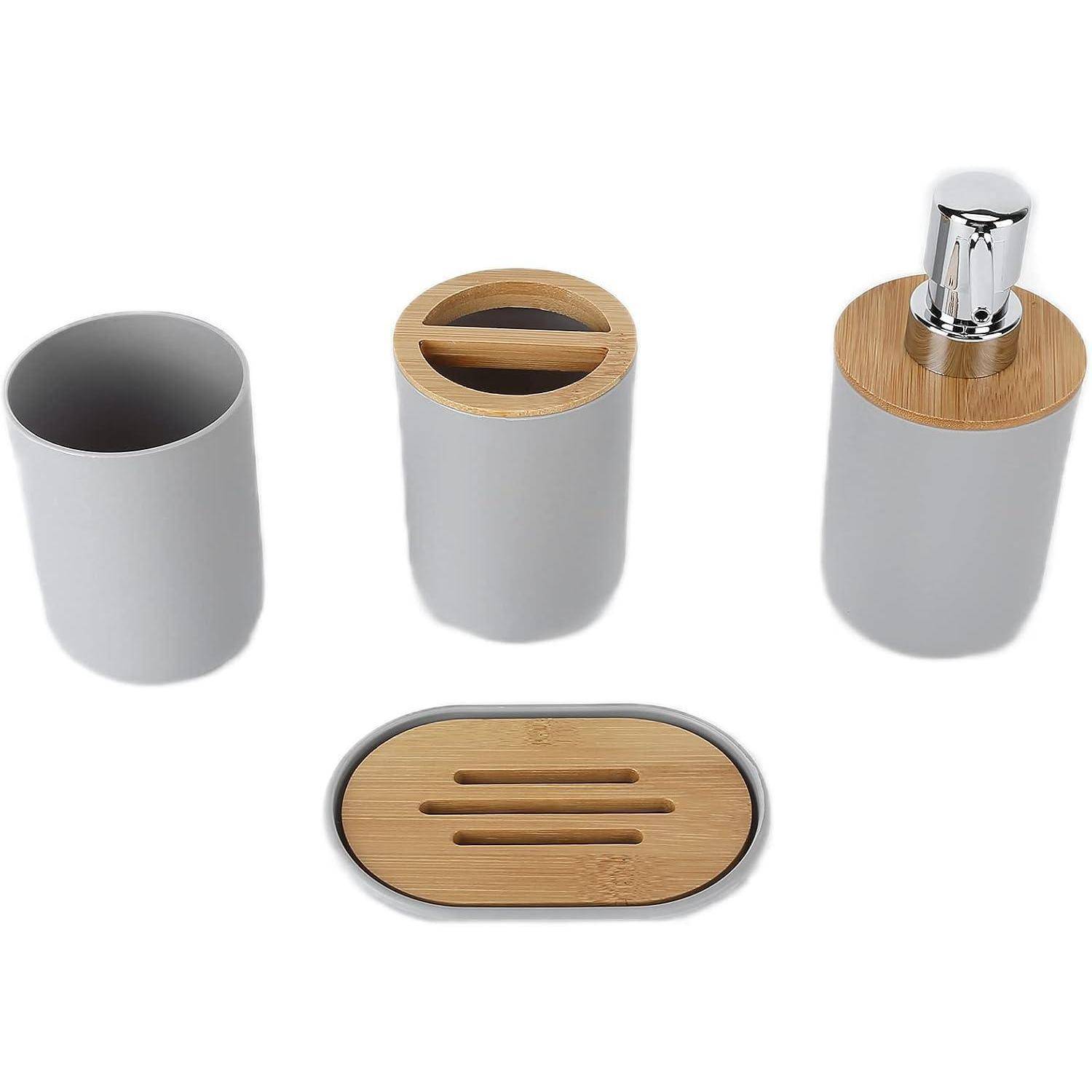 Satz grauer Badezimmeraccessoires mit Bambusdeckeln: Becher, Zahnbürstenhalter, Seifenspender und Seifenschale.