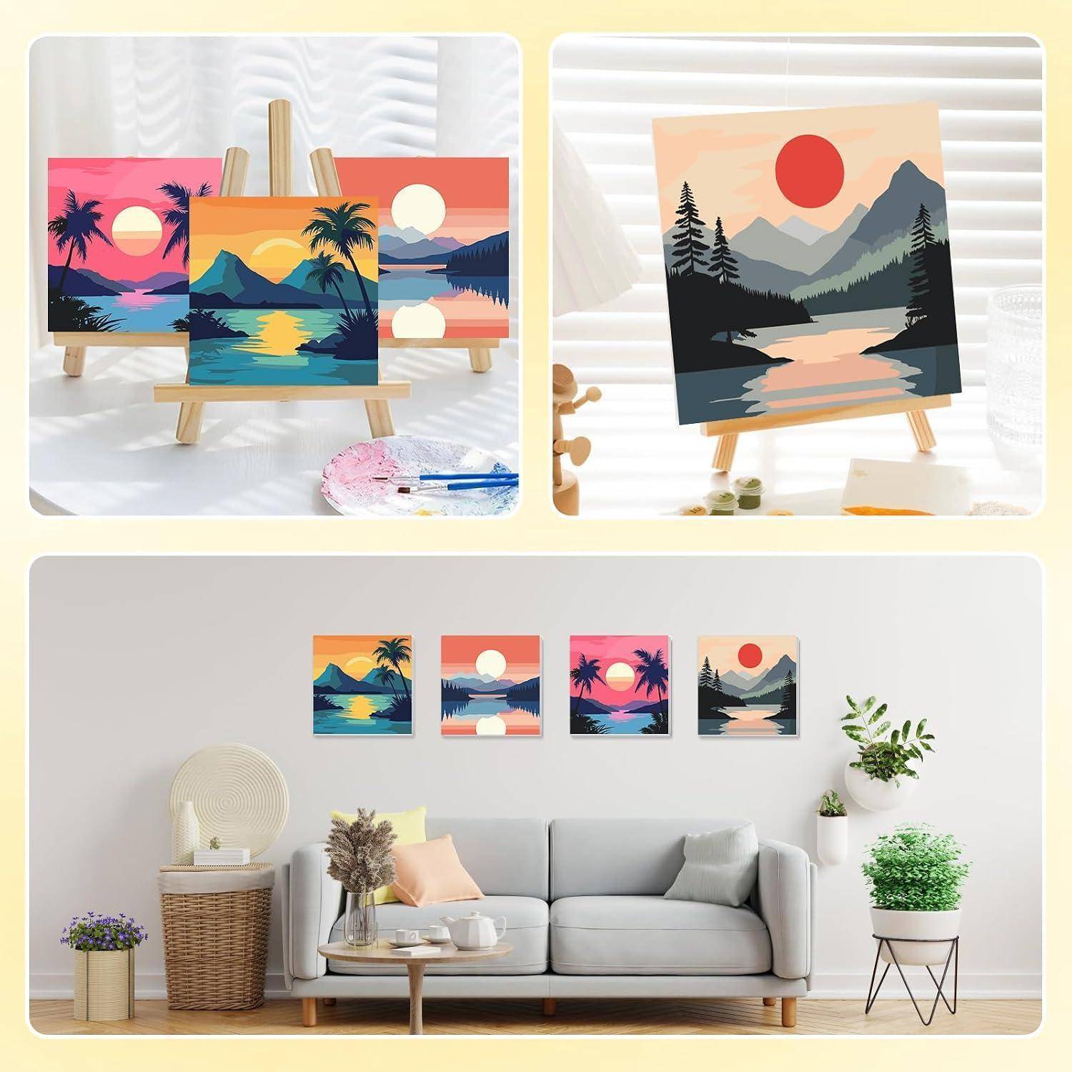 Dekorative Leinwanddrucke auf Staffeleien und eine Wandgestaltung im Wohnzimmer zeigen farbenfrohe Sonnenuntergantslandschaften und eine Bergszene über einem Sofa.