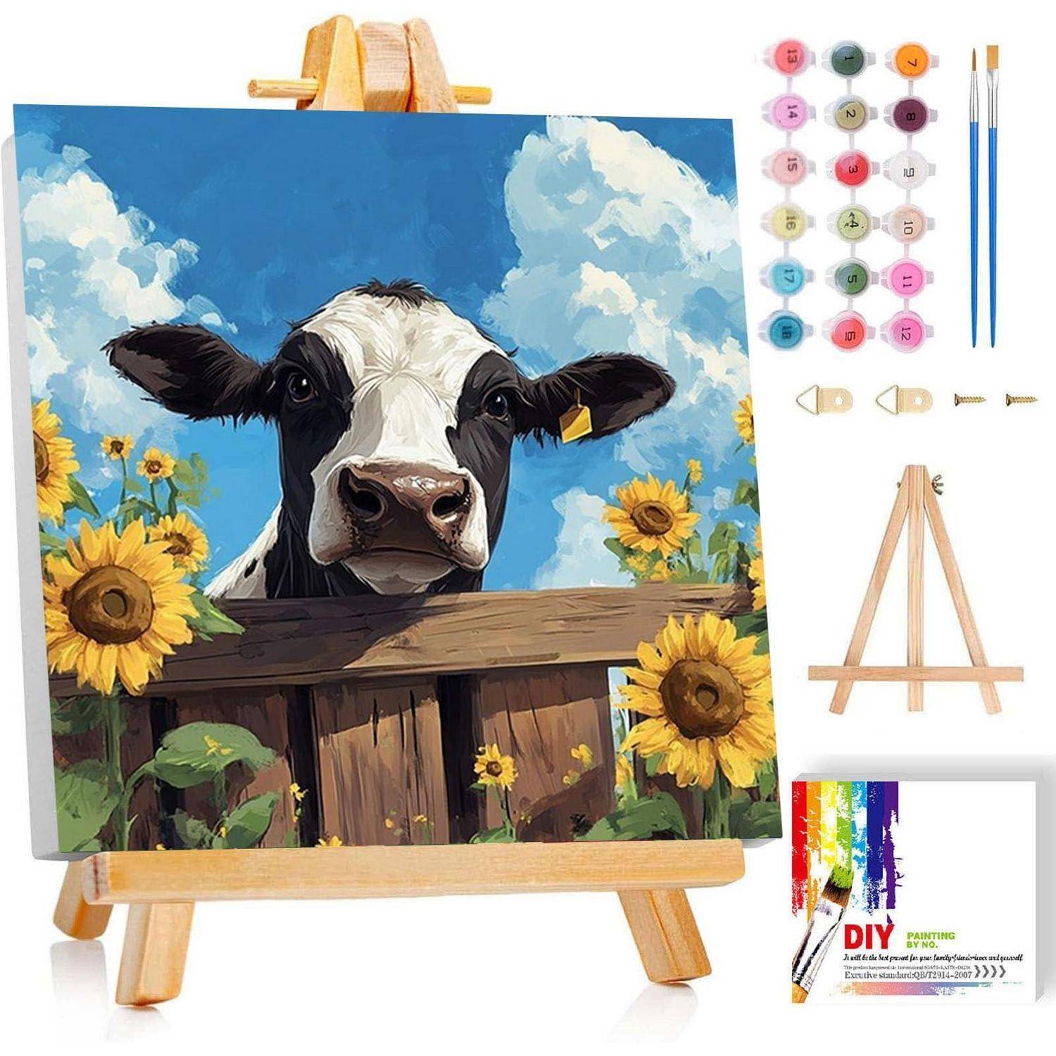 DIY-Malen-nach-Zahlen-Set auf einer Staffelei, das eine Kuh zeigt, die über einen Zaun neben Sonnenblumen unter blauem Himmel schaut, mit Farben, Pinseln und Leinwand im Lieferumfang enthalten.