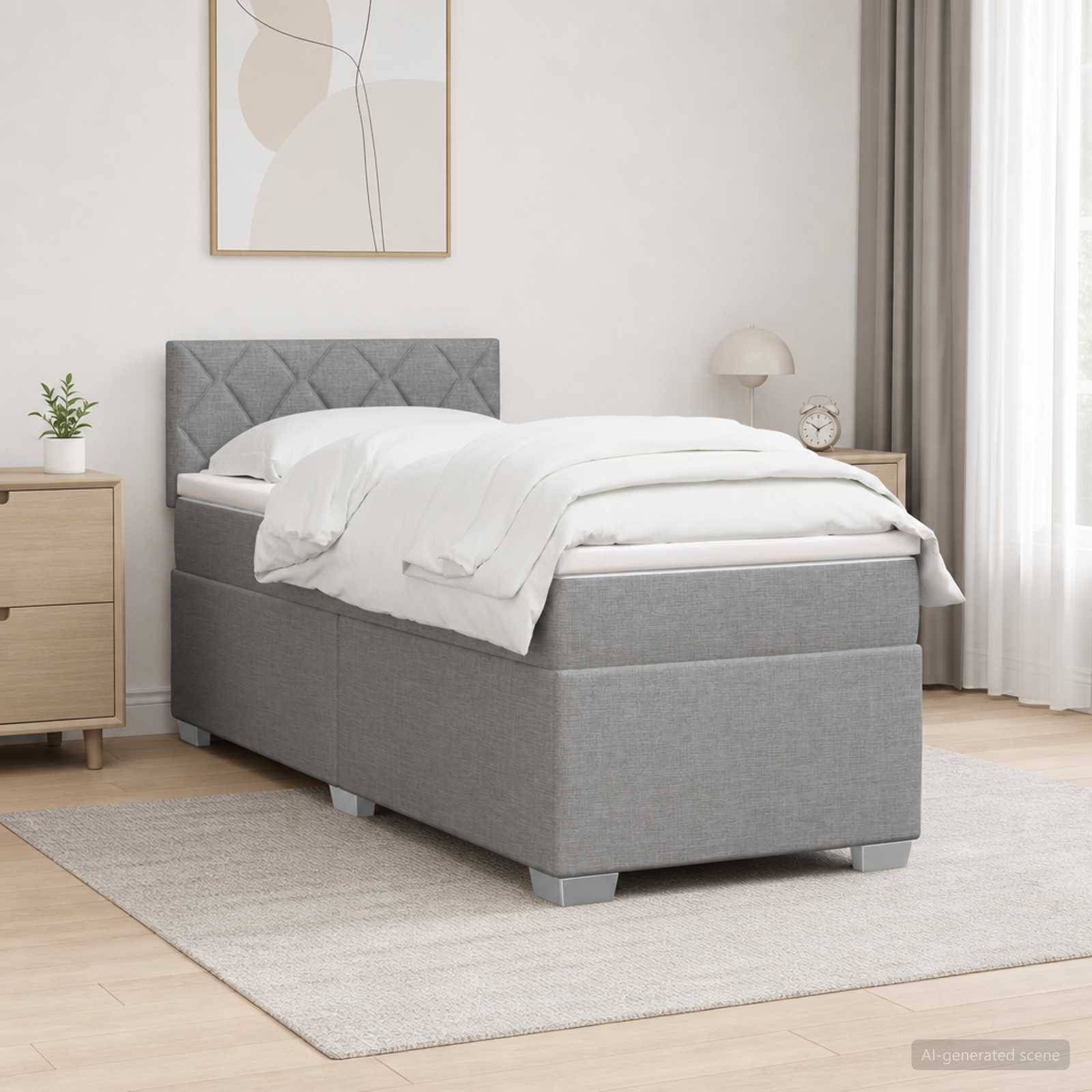 Graues gepolstertes Bett mit weißer Bettwäsche in einem minimalistischen Schlafzimmer, neben einem Nachttisch, einer Lampe, einer Pflanze und einer Wandkunst.
