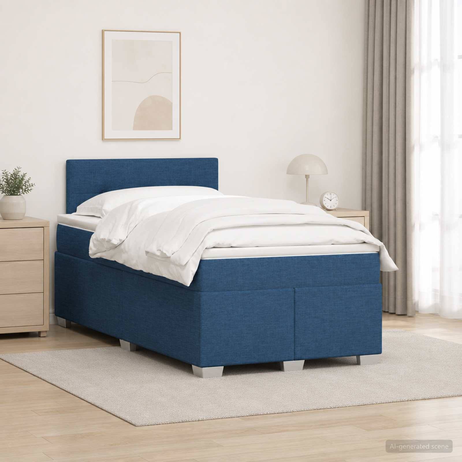 Blaues Polsterbett für eine Person mit weißer Bettwäsche in einem minimalistischen Schlafzimmer, neben einem Nachttisch, einer Lampe und Wandkunst im Rahmen.