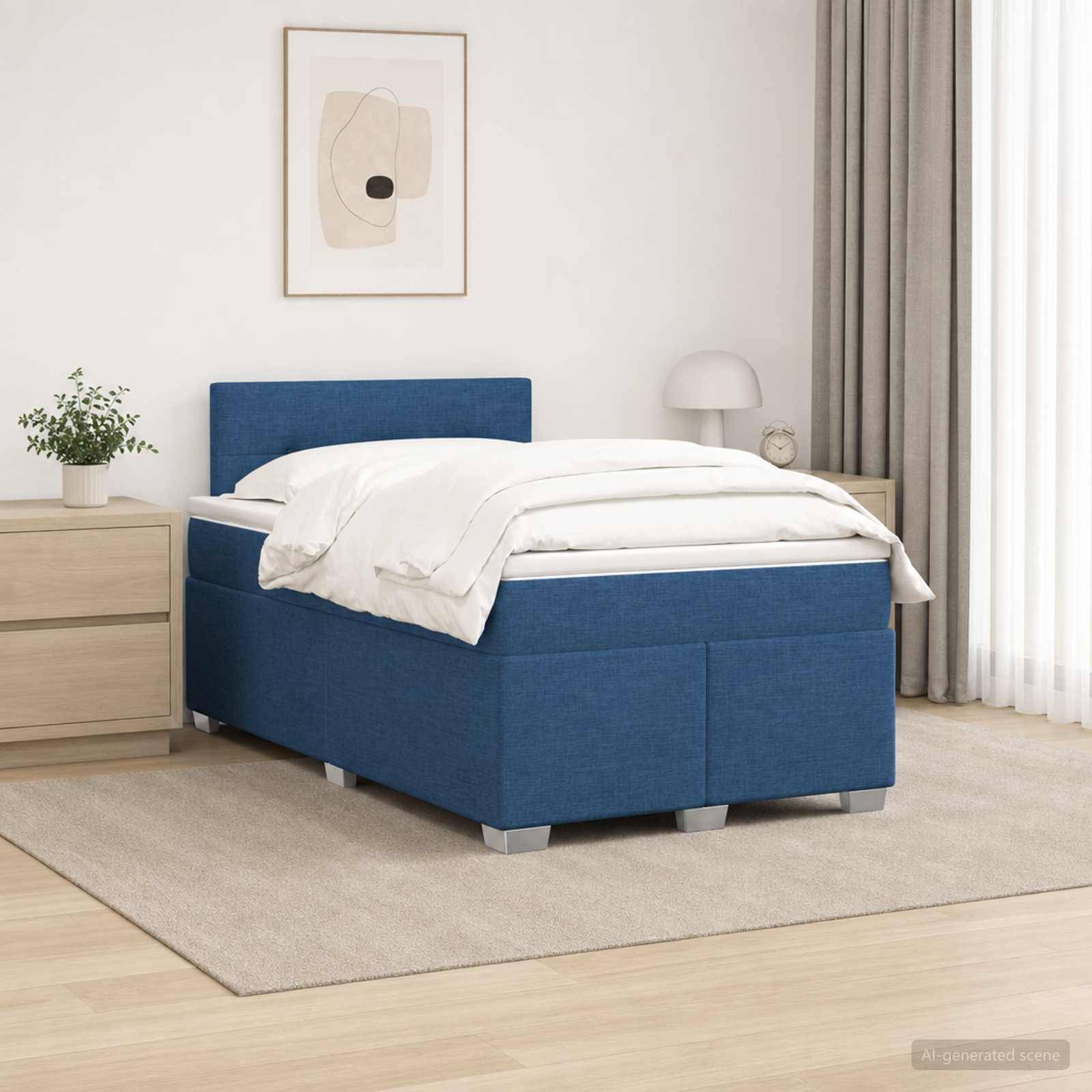 Blaues gepolstertes Bett mit weißer Bettwäsche in einem hellen, minimalistischen Schlafzimmer neben einem Nachttisch, einer Lampe, einer Pflanze und gerahmter Wandkunst.