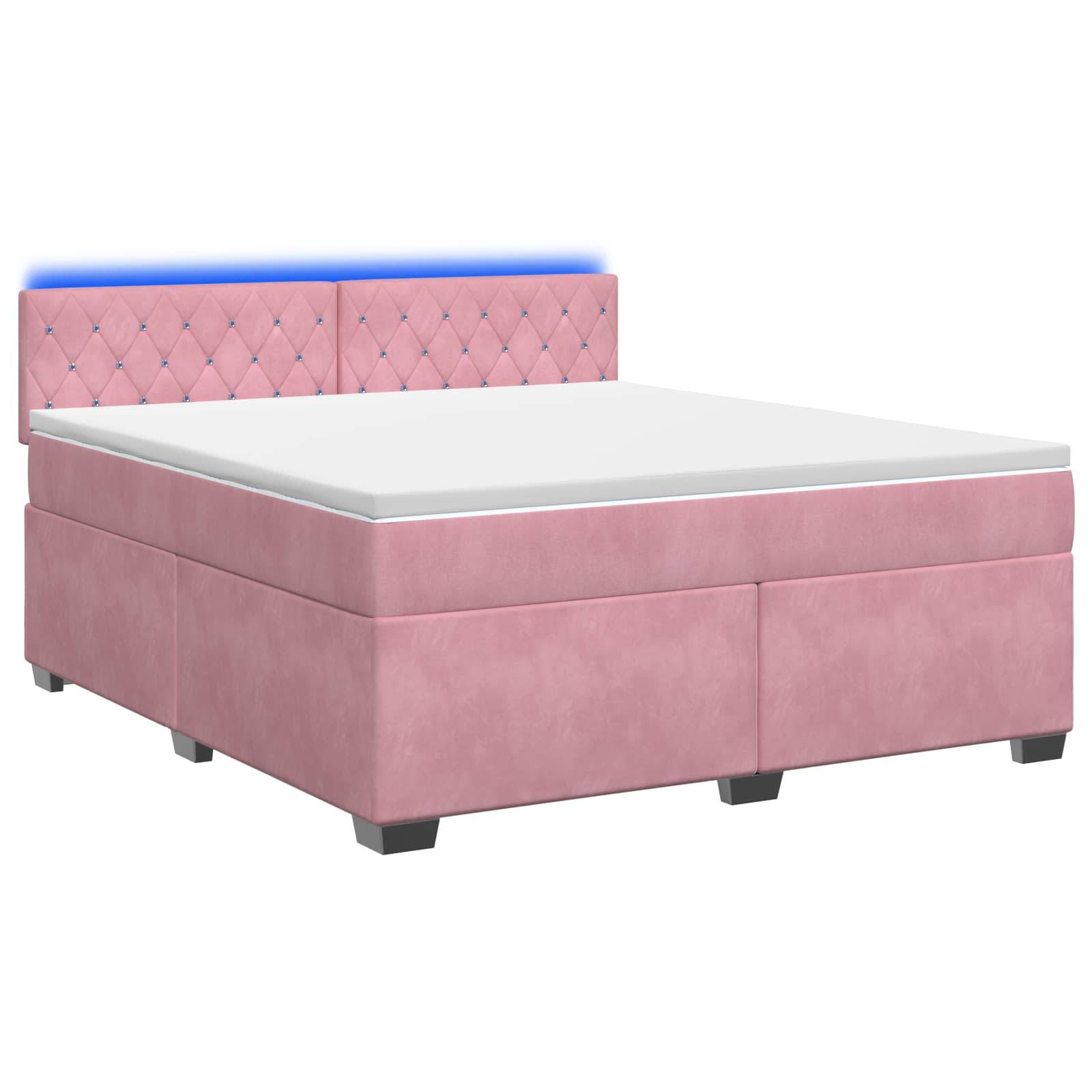 Rosa gepolstertes Bett mit gestepptem Kopfteil und weißer Matratze auf einfachem Hintergrund.