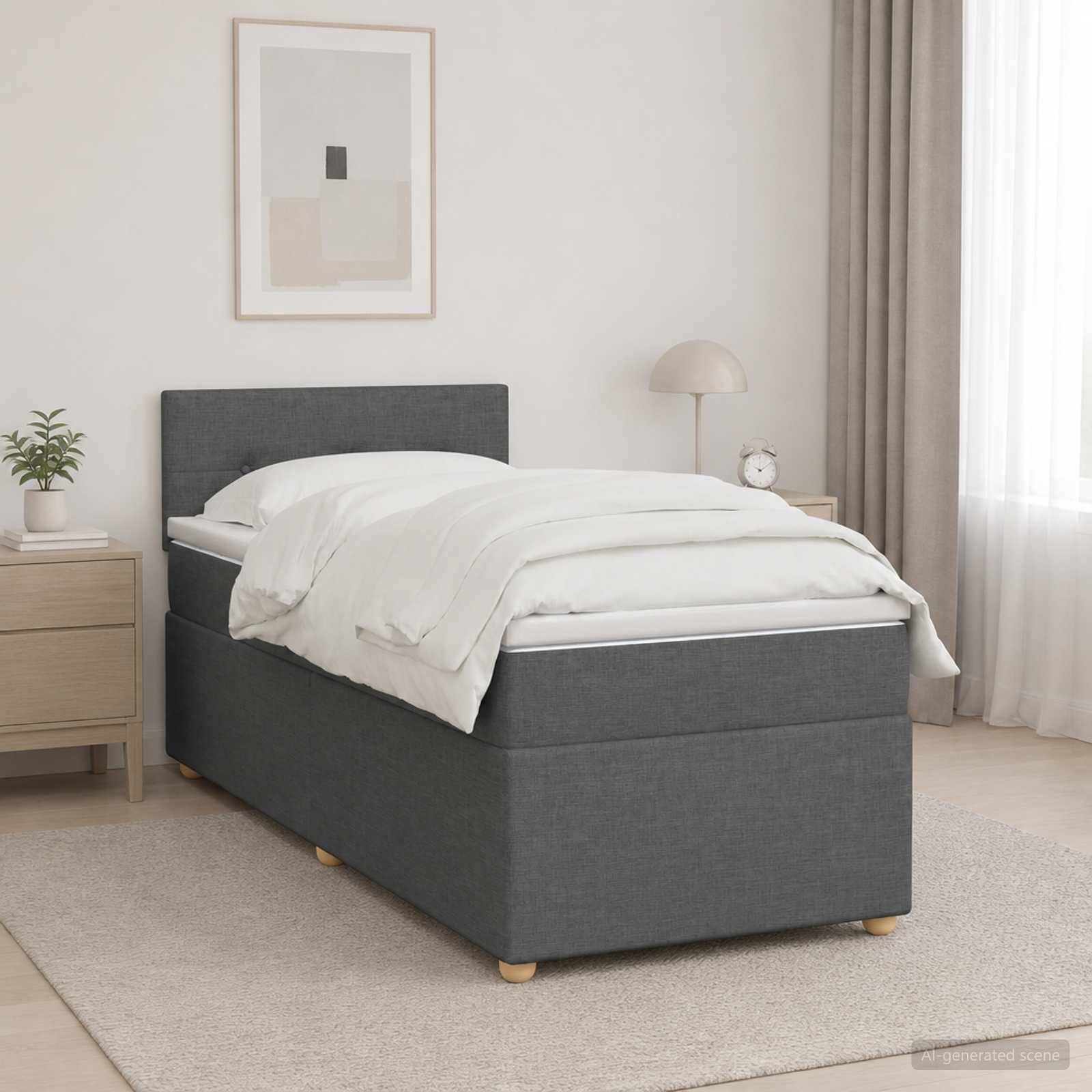 Modernes grau gepolstertes Einzelbett mit weißer Bettwäsche in einem hellen minimalistischen Schlafzimmer, neben einem Nachttisch, einer Lampe, einer Pflanze und gerahmter Wandkunst.