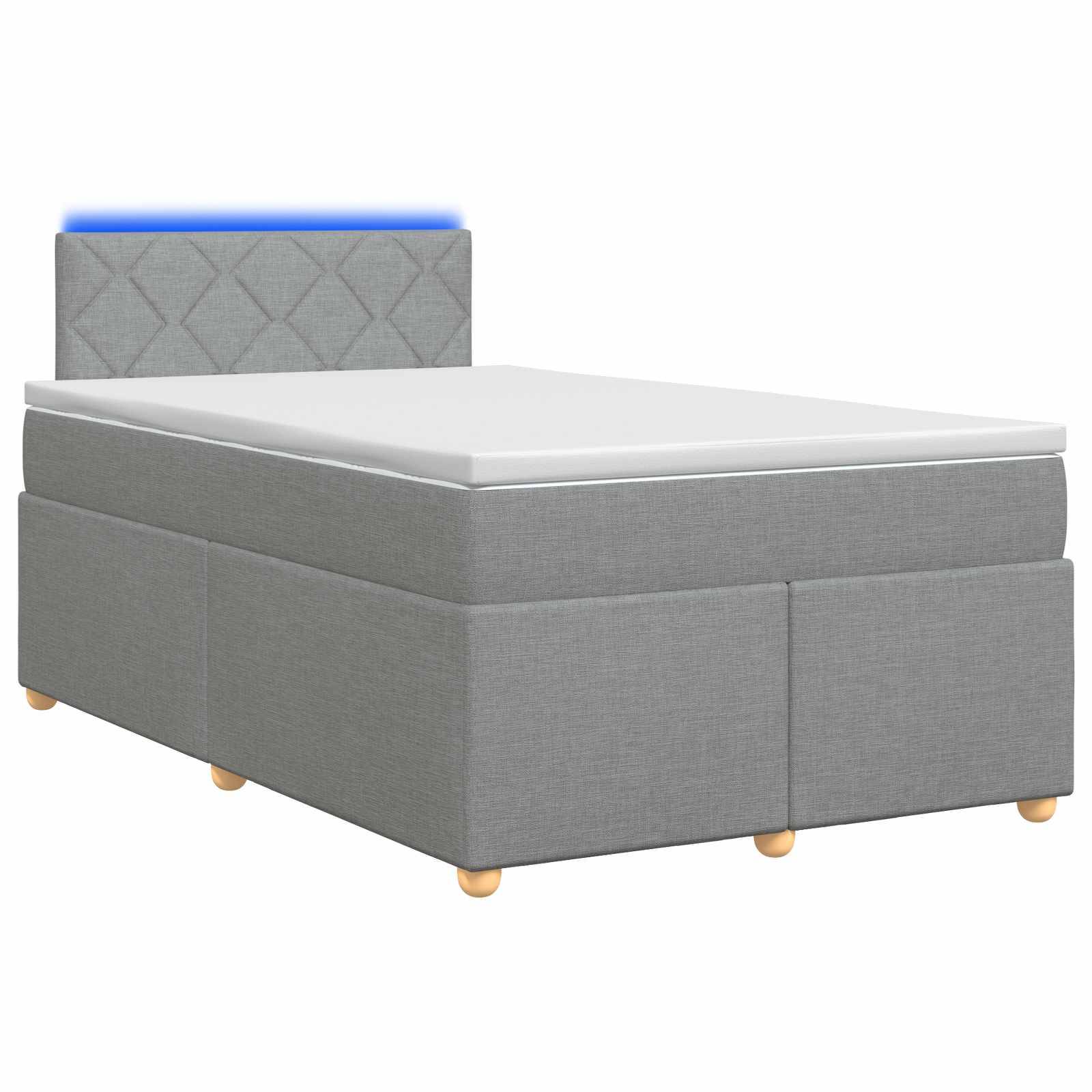 Grau gepolstertes Einzelbett mit weißer Matratze, gestepptem Kopfteil und kleinen Holzbeinen auf weißem Hintergrund.