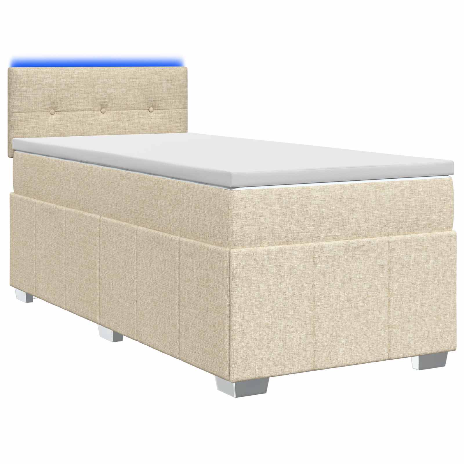 Beige gepolstertes Einzelbett mit gestepptem Kopfteil und weißer Matratze auf einfachem Hintergrund.