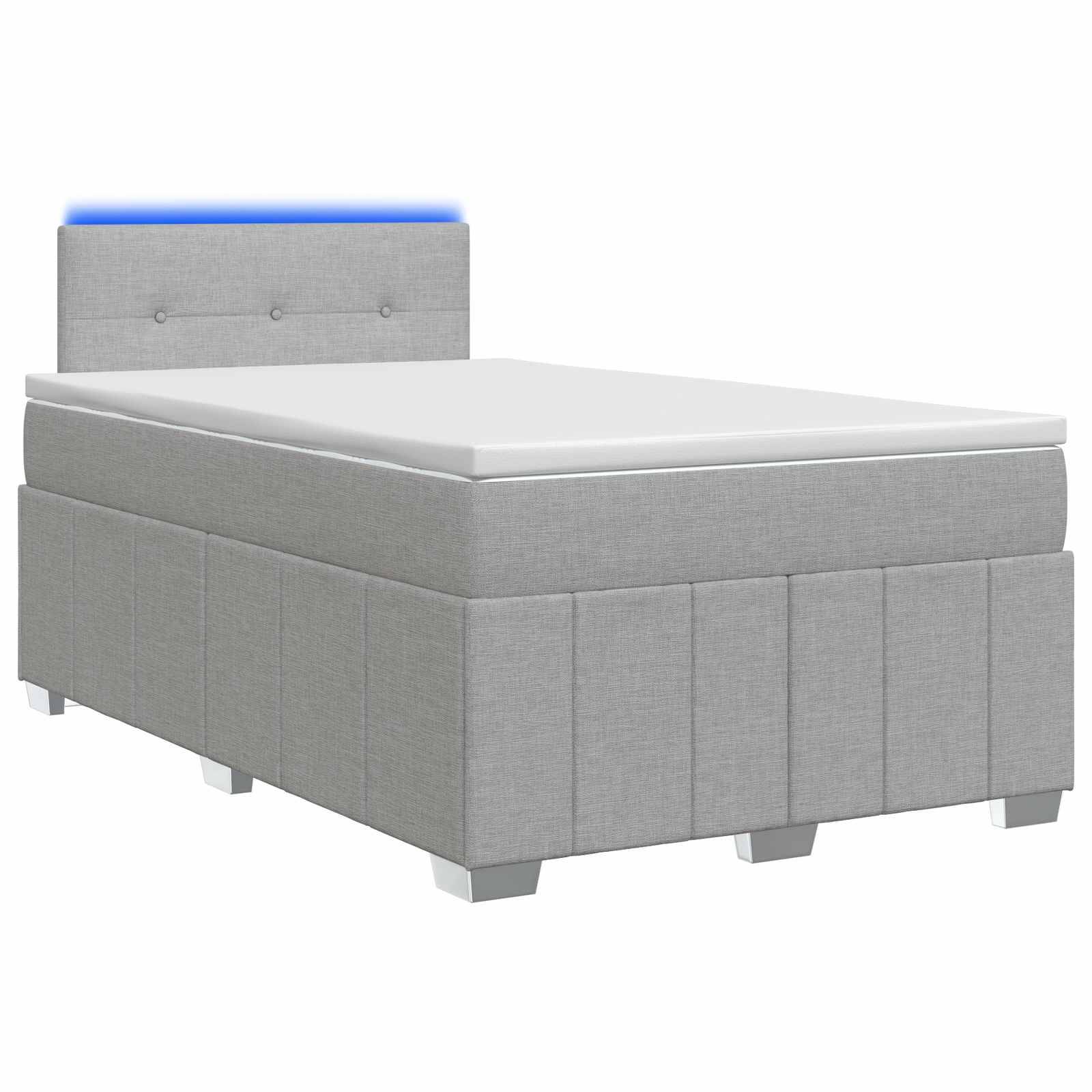 Graues gepolstertes Einzelbett mit Matratze und gestepptem Kopfteil mit Knopfheftung auf weißem Hintergrund.