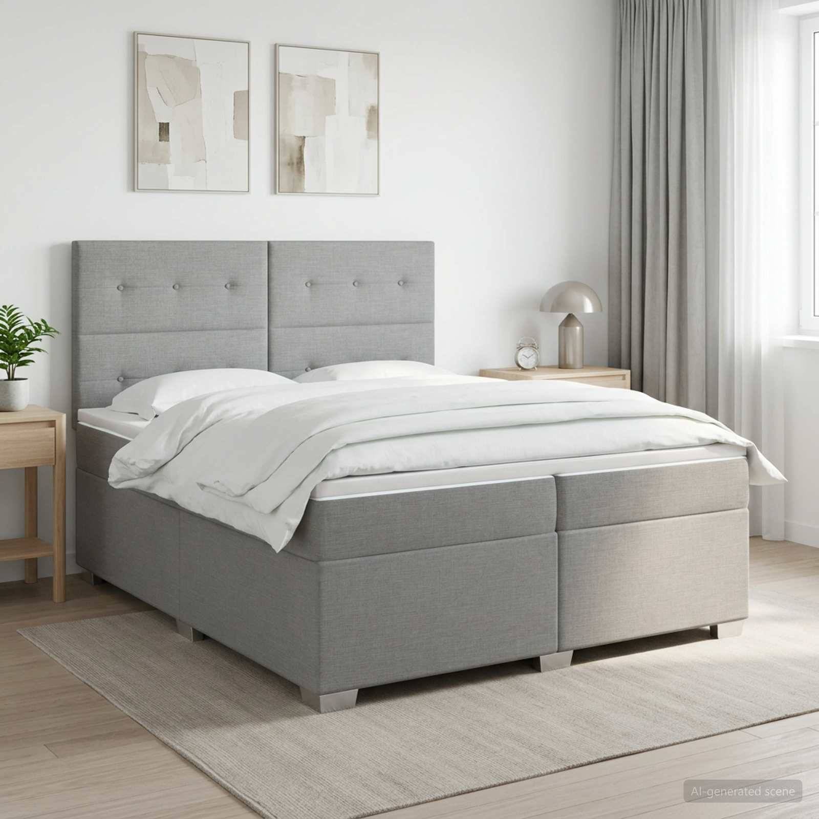 Modernes Schlafzimmer mit grauem gepolstertem Bett, weißer Bettwäsche, Nachttischen, gerahmten Wandbildern und sanftem Naturlicht.