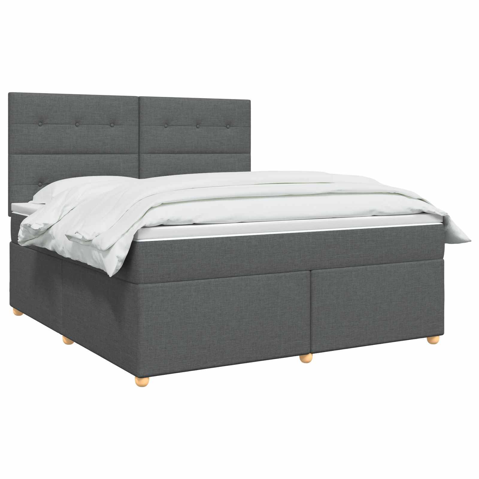 Graues gepolstertes Doppelbett mit kapitoniertem Kopfteil und weißer Bettwäsche auf neutralem Hintergrund.