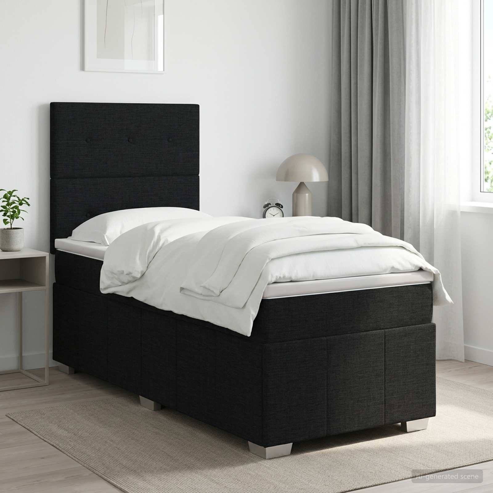 Schwarzes gepolstertes Einzelbett mit weißer Bettwäsche in einem hellen, minimalistischen Schlafzimmer neben einem Fenster und einem Nachttisch.