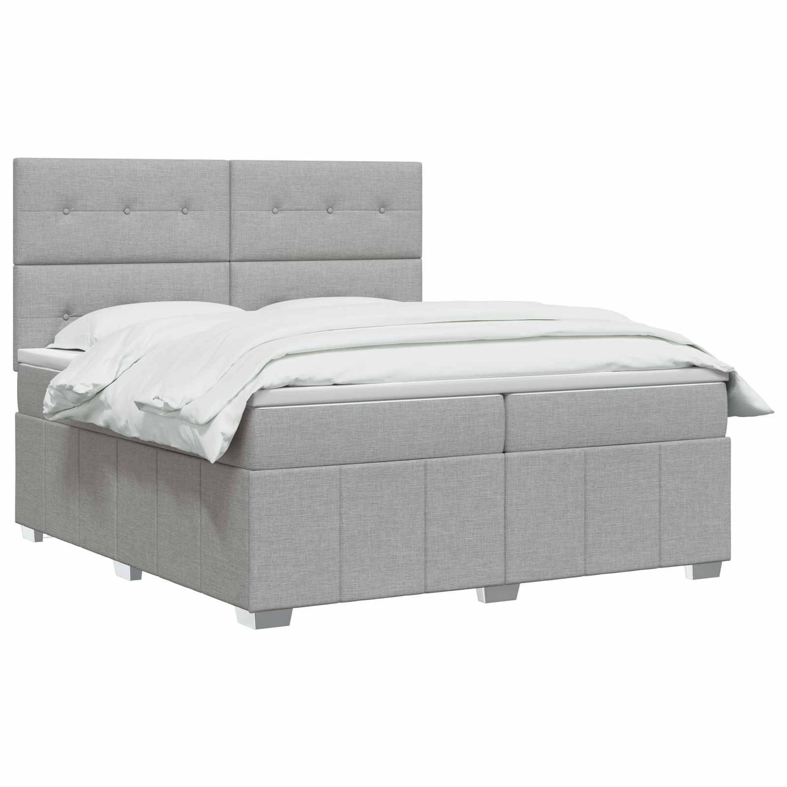Grau gepolstertes Bett mit gestepptem Kopfteil, weiße Bettwäsche, auf einfachem weißem Hintergrund gezeigt.