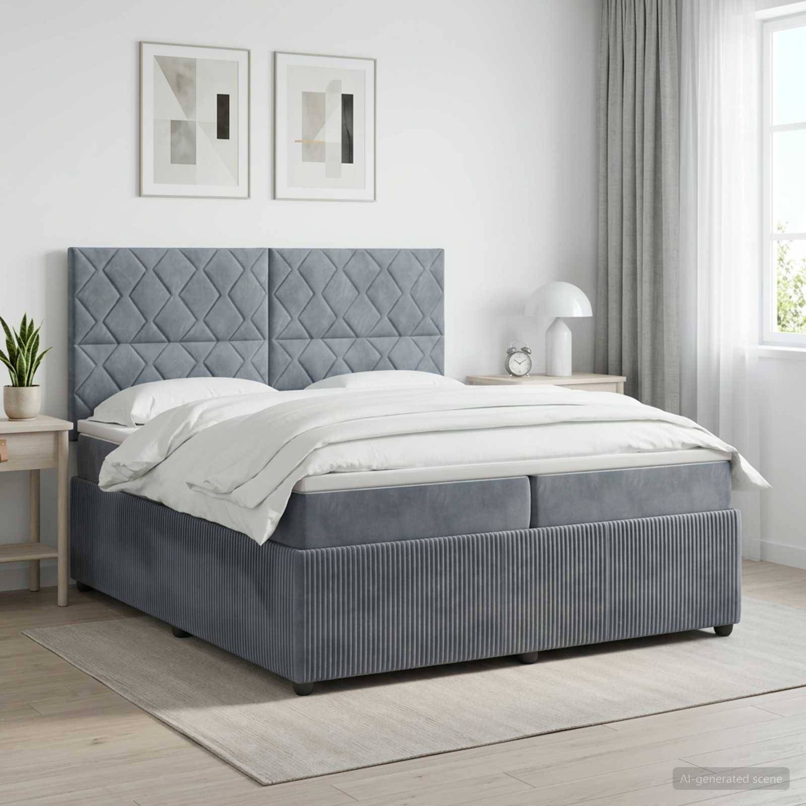 Modernes graupolstertes Bett mit gestepptem Kopfteil in einem hellen Schlafzimmer, bezogen mit weißer Bettwäsche und flankiert von Nachttischen sowie gerahmten Wandbildern.
