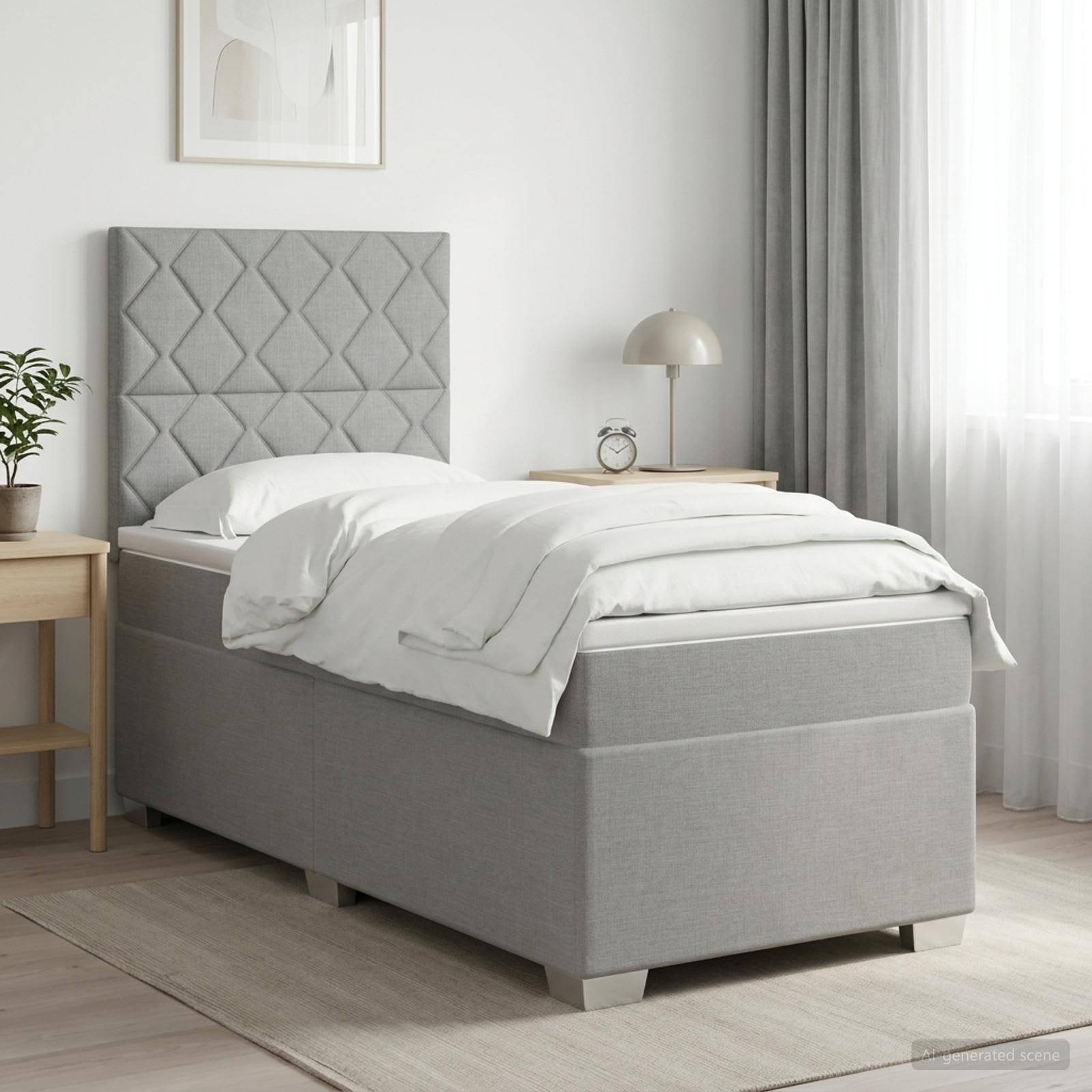 Grau gepolstertes Einzelbett mit gestepptem Kopfteil, weiße Bettwäsche und Nachttisch in einem hellen, minimalistischen Schlafzimmer.