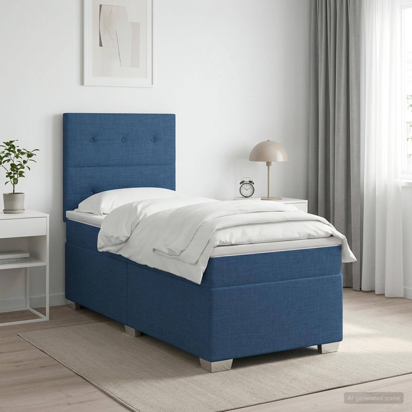 Bett mit blauem Polsterbezug in hellem, minimalistischem Schlafzimmer mit weißem Nachttisch, Lampe, Pflanze, Vorhängen und gerahmter Kunst.