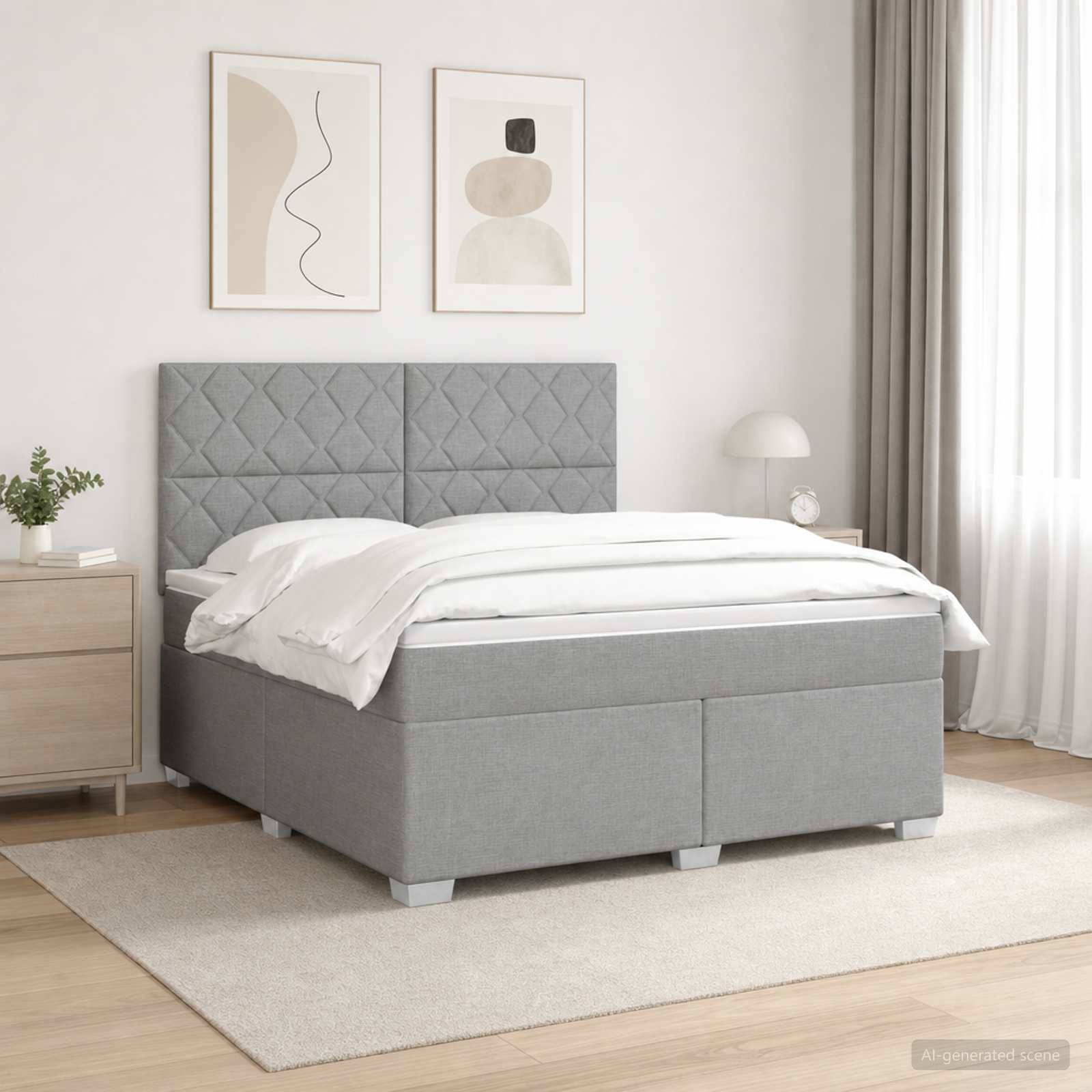 Modernes graupolstertes Bett mit gestepptem Kopfteil in einem minimalistischen Schlafzimmer, ausgestattet mit weißer Bettwäsche, Nachttisch, Lampe, Kunstwerk und Teppich.