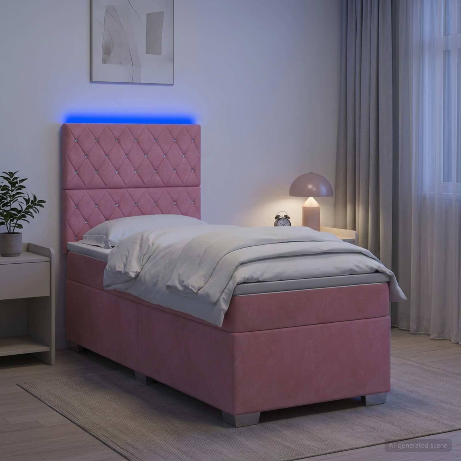 Rosa gepolstertes Einzelbett mit beleuchtetem blauem Kopfteil in einem modernen Schlafzimmer, ordentlich mit grauer Bettwäsche gemacht neben einem Nachttisch und einer Lampe.