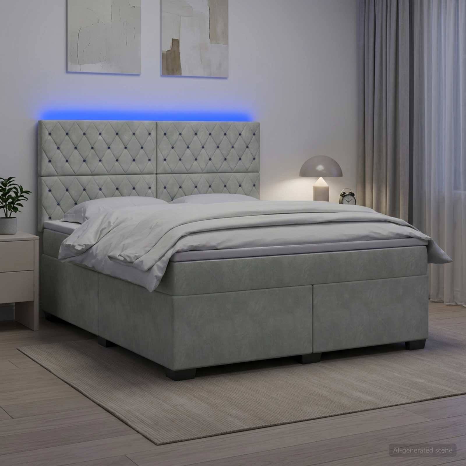 Modernes graupolstertes Bett mit gestepptem Kopfteil und blauer LED-Hintergrundbeleuchtung in einem Schlafzimmer, gefertigt mit weißer Bettwäsche neben einem Nachttisch und einer Lampe.