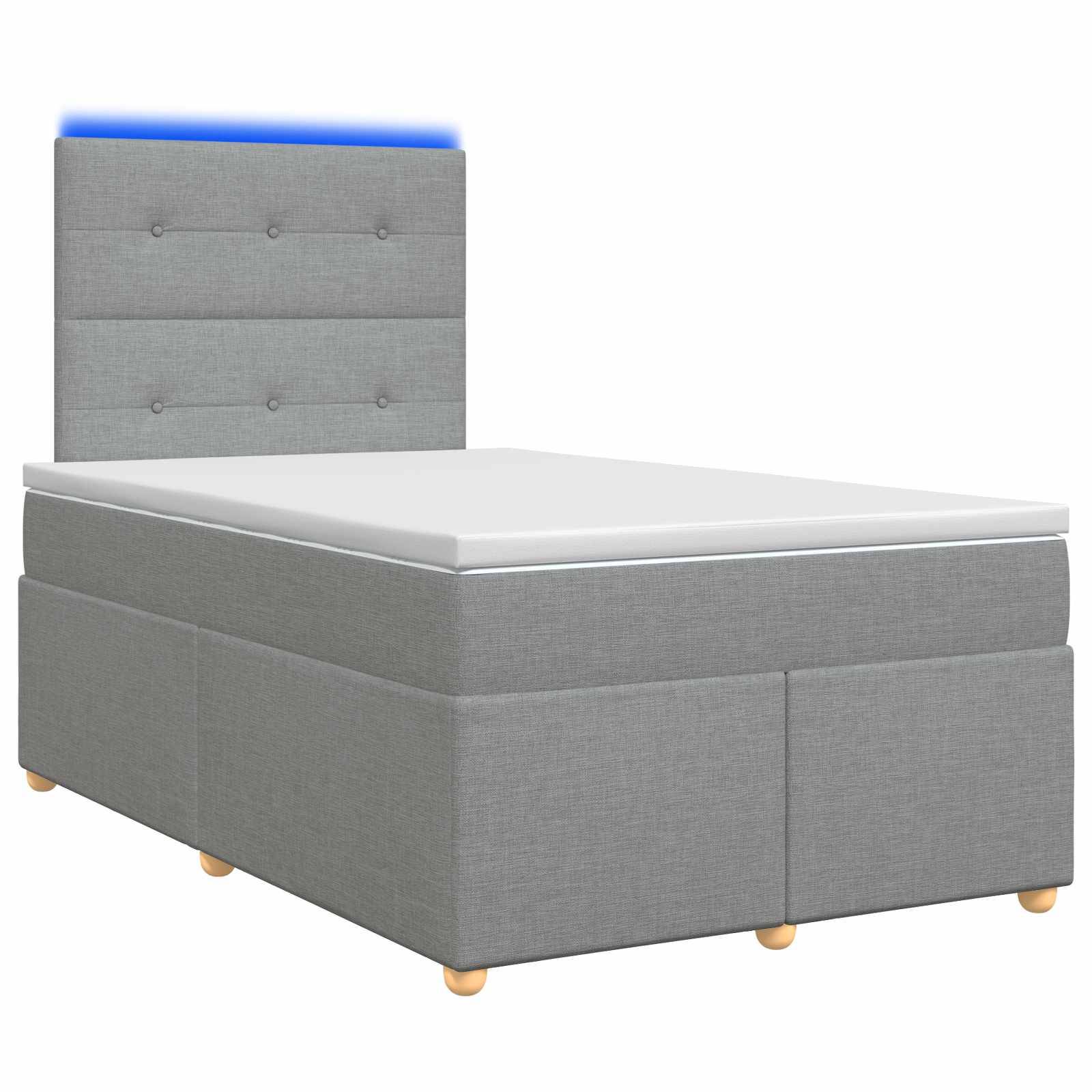 Grau gepolstertes Einzelbett mit gestepptem Kopfteil, weiße Matratze und Speicherbasis auf Holzbeinen, auf weißem Hintergrund gezeigt