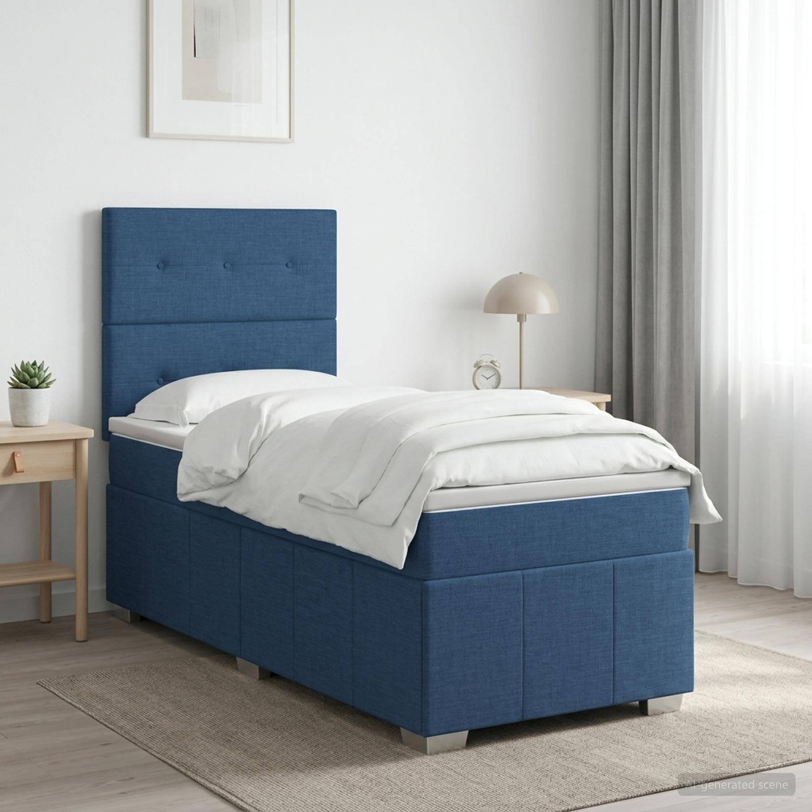Blaugepolstertes Einzelbett mit weißer Bettwäsche in einem hellen minimalistischen Schlafzimmer, neben einem kleinen Holztisch, einer Lampe und Vorhängen.