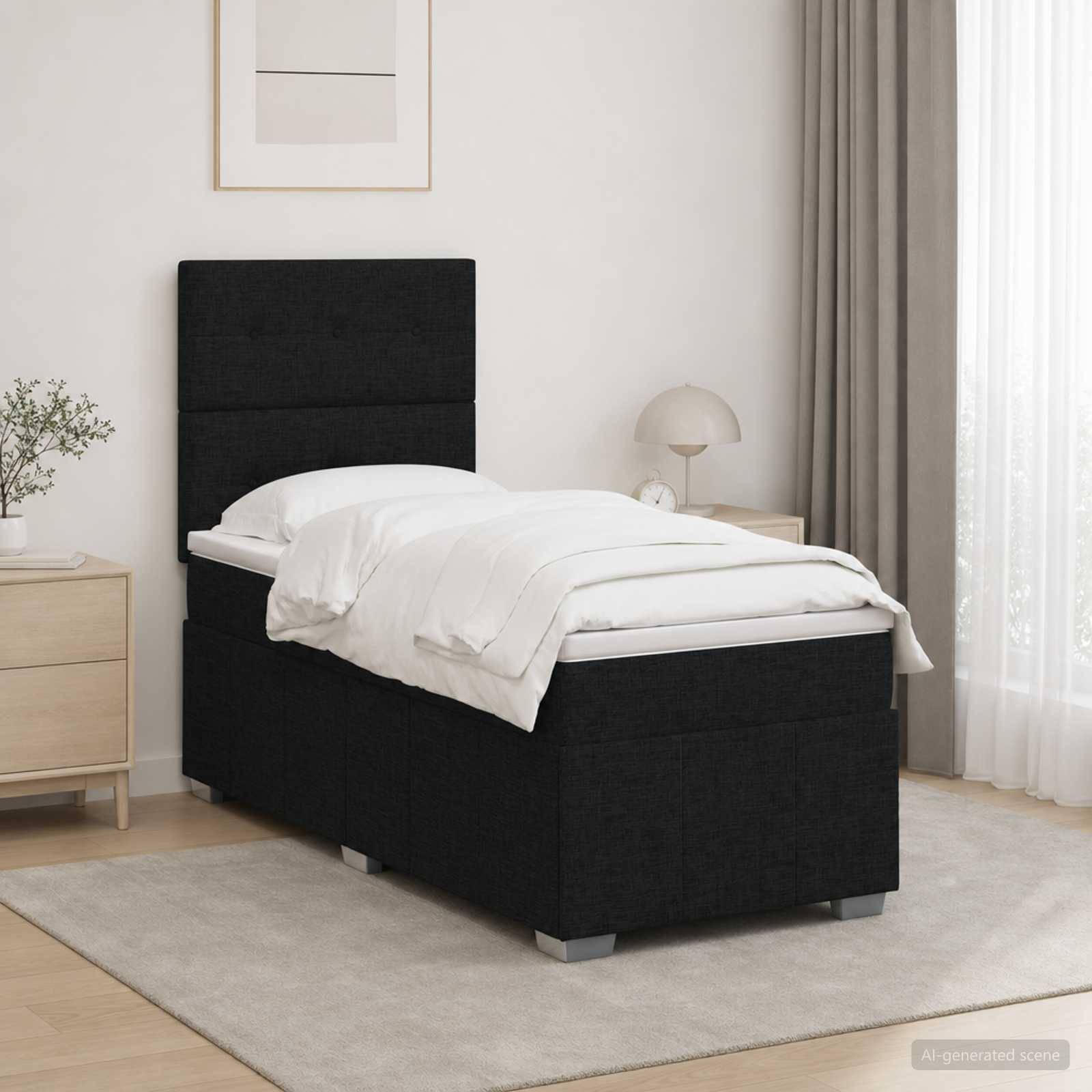 Einzelnes schwarzes Polsterbett mit weißer Bettwäsche in einem minimalistischen Schlafzimmer, neben einem Nachttisch und einer Lampe auf einem hellen Teppich