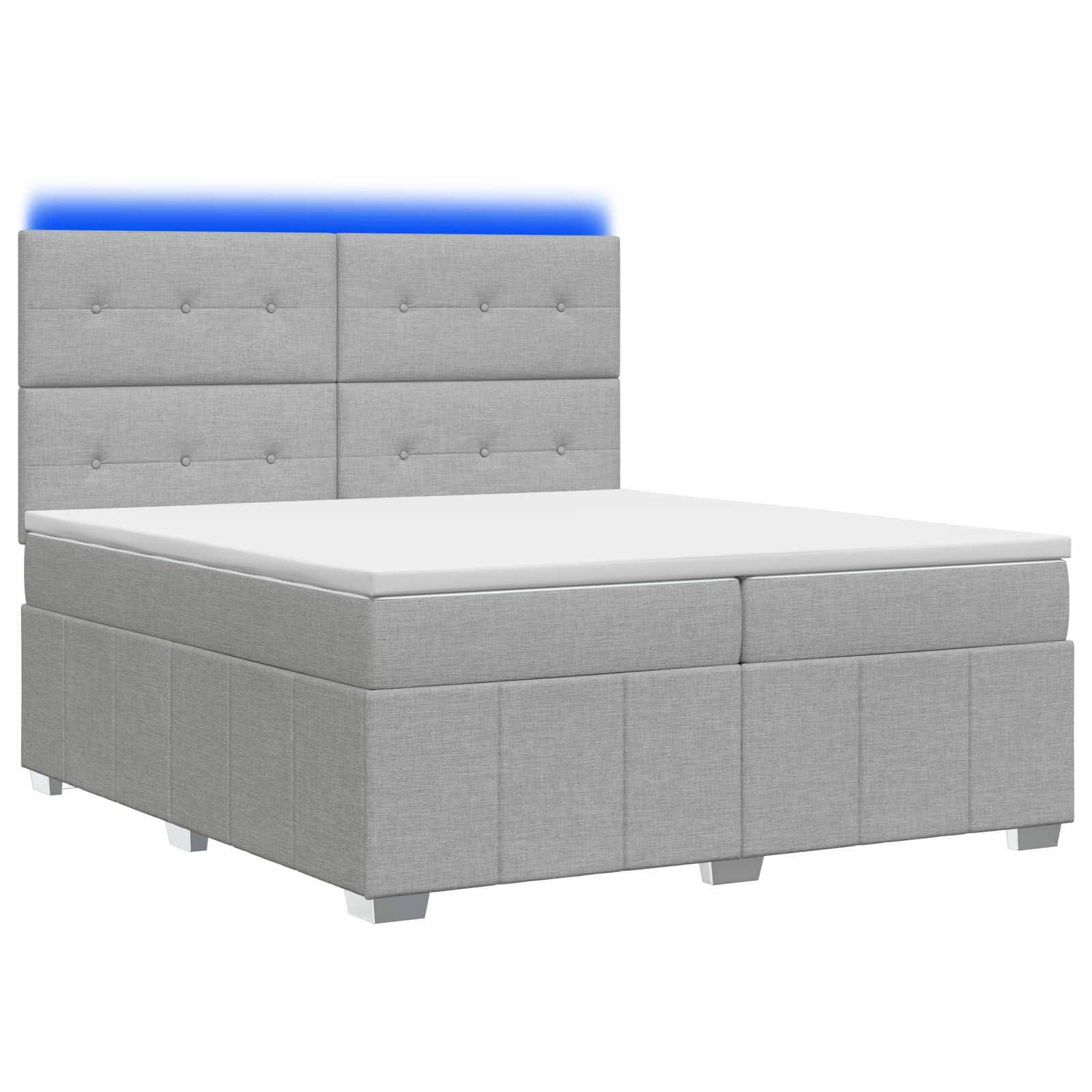Grau gepolstertes Bett mit Knopf-gestepptem Kopfteil und integriertem blauem LED-Lichtstreifen hinter dem Kopfteil.