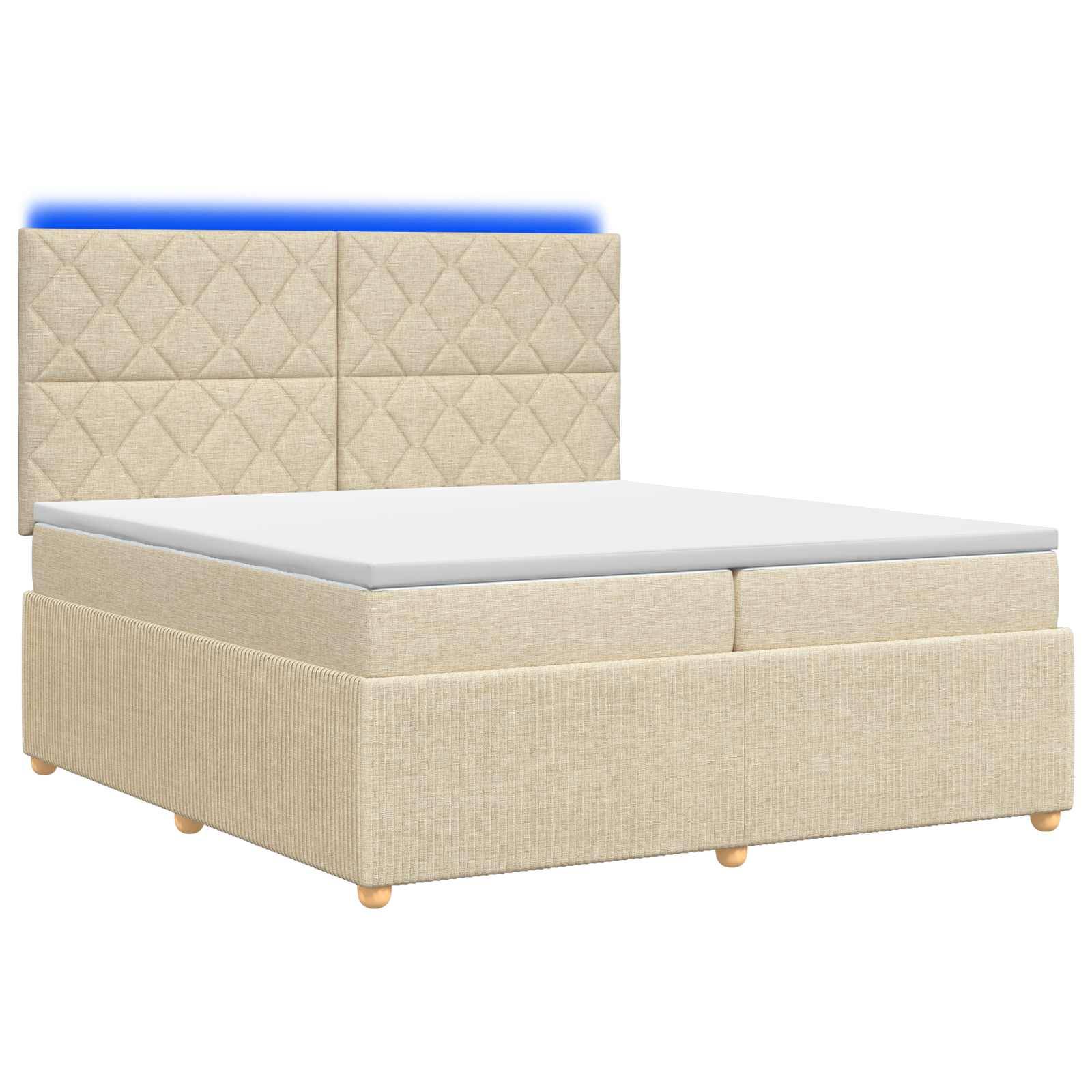 Beige gepolstertes Bett mit gestepptem Kopfteil, weißer Matratze und Stauraumbasis auf schlicht weißem Hintergrund.