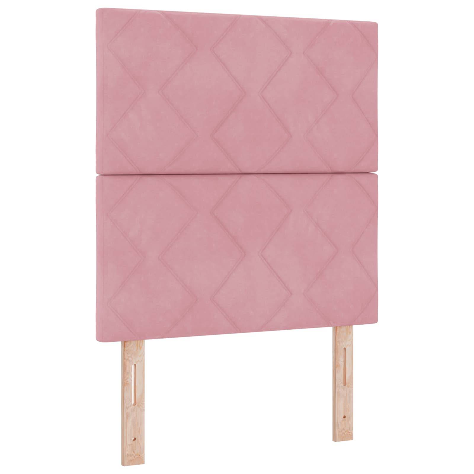 Rosa gepolstertes Kopfteil mit Rautensteppung und zwei Holzbeinen auf weißem Hintergrund.