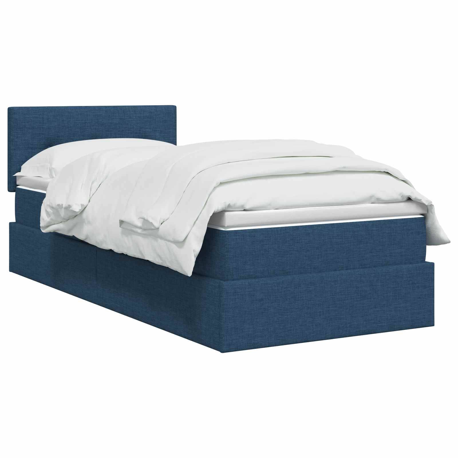 Bett mit blauem Polsterbezug und weißer Bettwäsche vor neutralem Hintergrund.