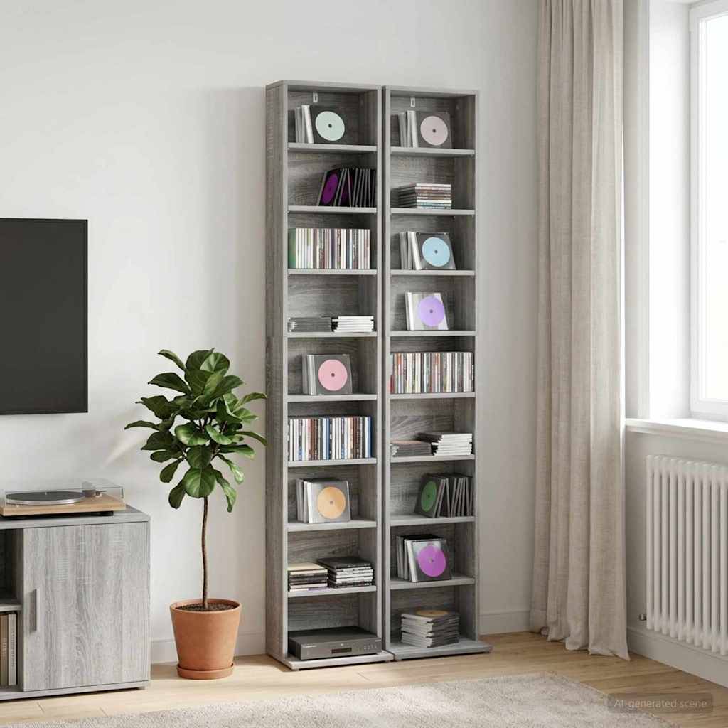 Modernes Wohnzimmer mit zwei hohen grauen CD-Regalen gefüllt mit Discs, einer Topfpflanze, einem Fernsehständer, einem Fenster mit Vorhängen und einem Heizkörper.