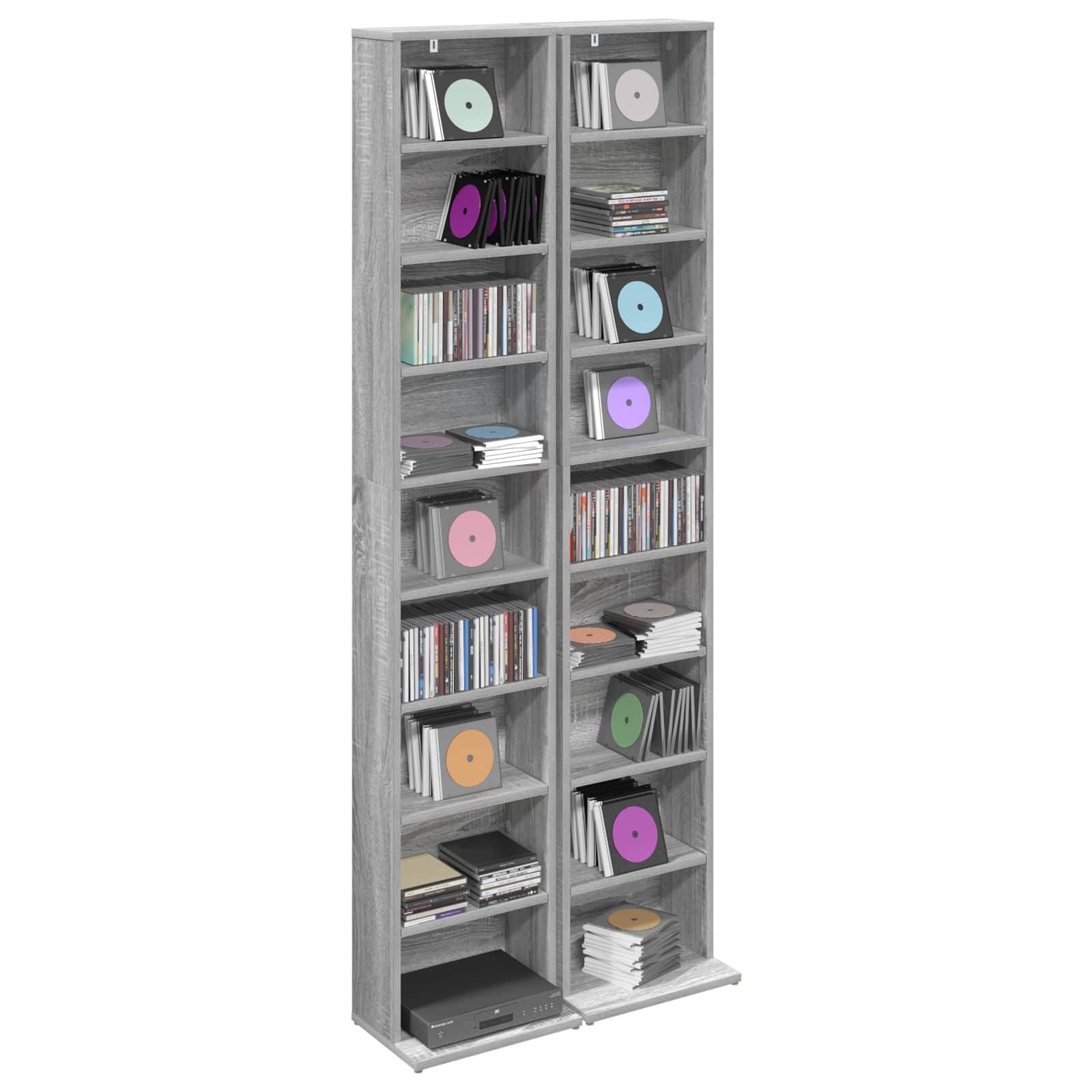 Hoher grauer Medienschrank mit zwei Regalsäulen für CDs, DVDs und Spielkassetten sowie einer unteren Stereokomponente.