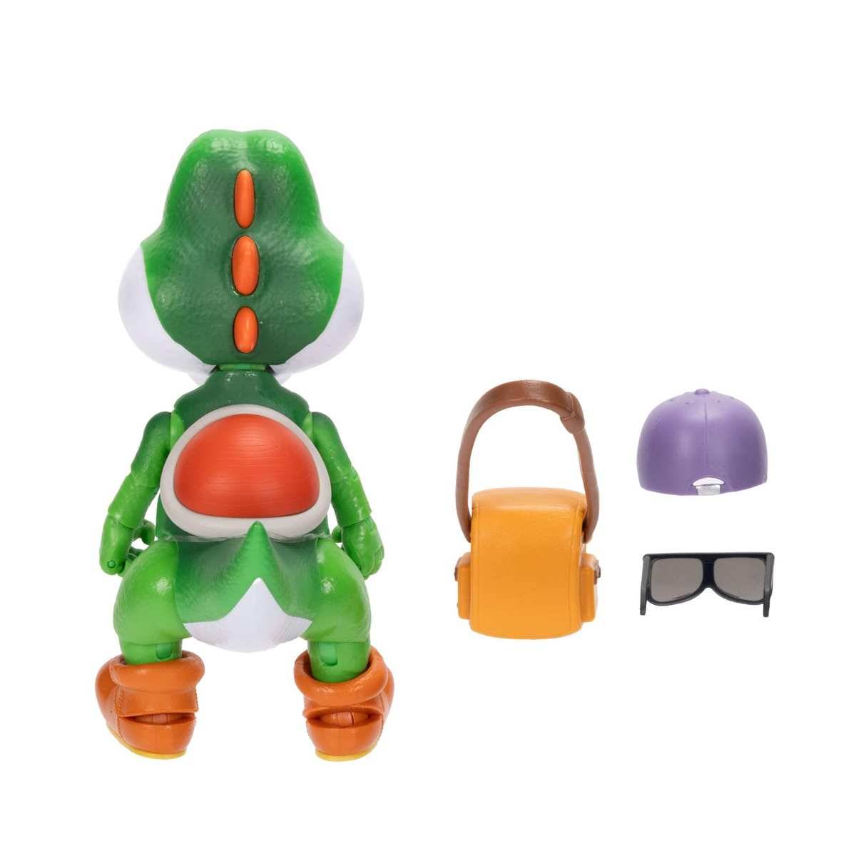 Spielzeug-Dinosaurierfigur von hinten gezeigt mit abnehmbarem Zubehör daneben: orange Tasche, violette Mütze und schwarze Brille.
