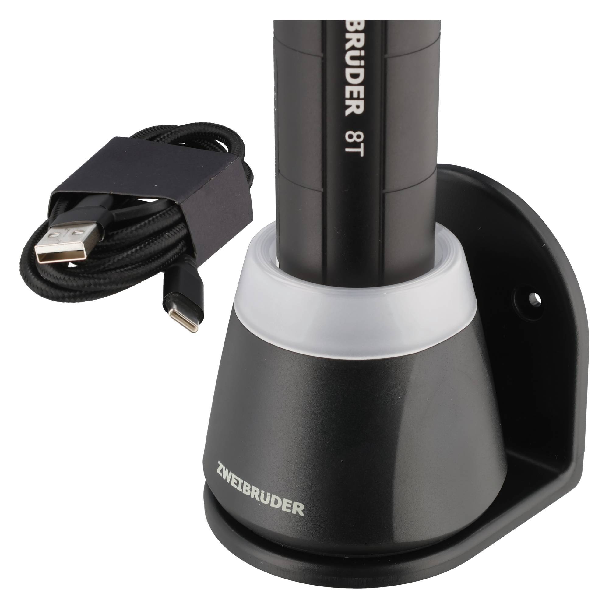 Schwarze USB-Ladeschale, die ein BRUDER 8T-Gerät hält, mit aufgewickeltem USB-Kabel daneben.
