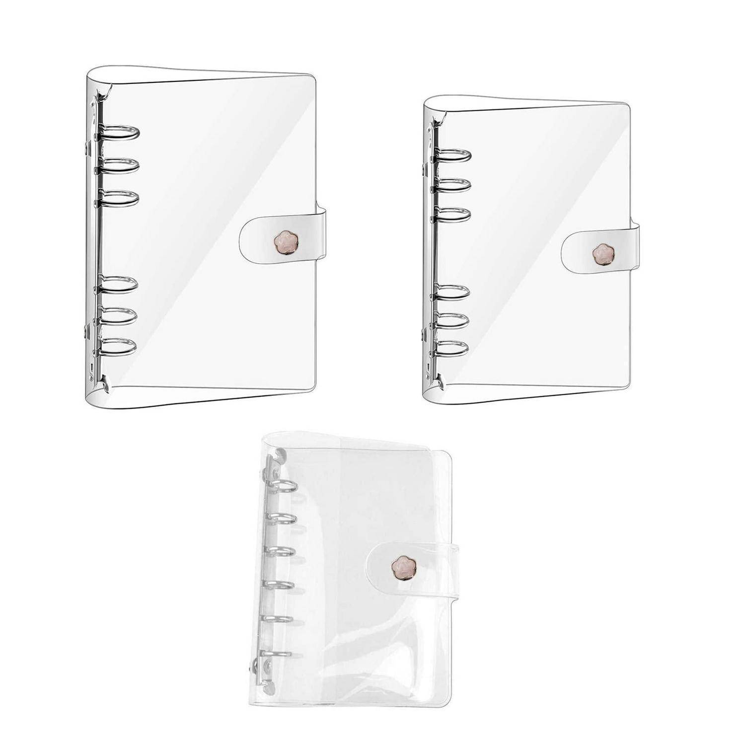 Drei transparente Spiralbindungs-Notizbuchcover mit Druckknopfverschlüssen, dargestellt in schwarzer Kontur-, weiß- und durchsichtiger Ausführung auf einem einfachen Hintergrund.