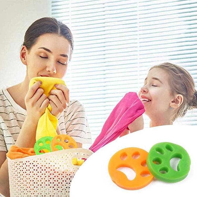 Mutter und Tochter spielen mit bunten Kunststoffringen und Tüchern in einem hellen Raum, was auf Sensomotorik- oder Stapelspielzeug hindeutet.