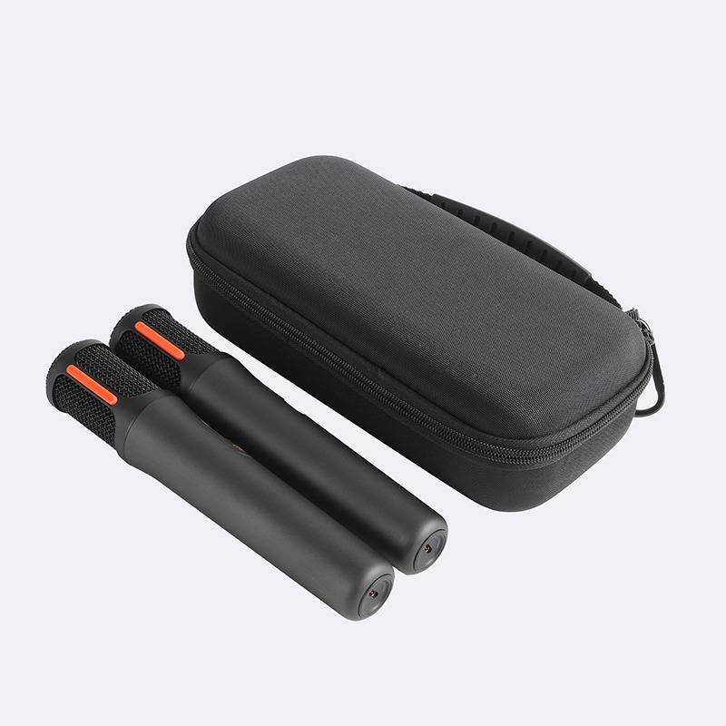 Paar schwarze Handkrafttrainer mit orangefarbenen Akzenten neben einem schwarzen Reißverschluss-Tragetasche auf weißem Hintergrund.
