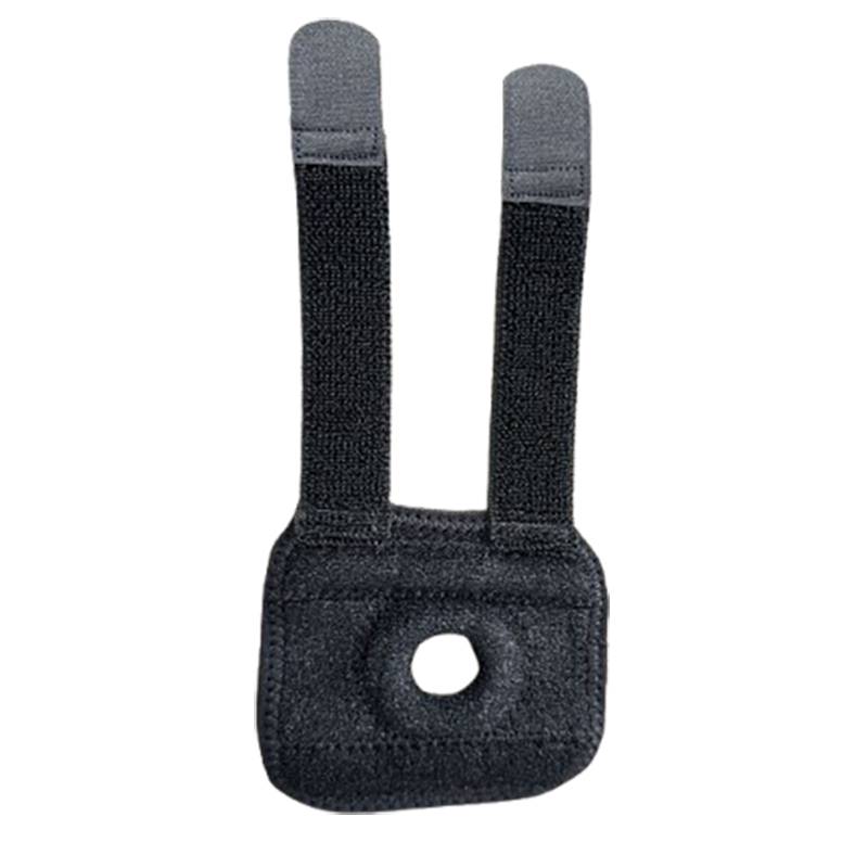 Schwarzes Stoffband mit zwei vertikalen Klettverschluss-Laschen und einem zentralen Loch auf einer gepolsterten rechteckigen Basis.