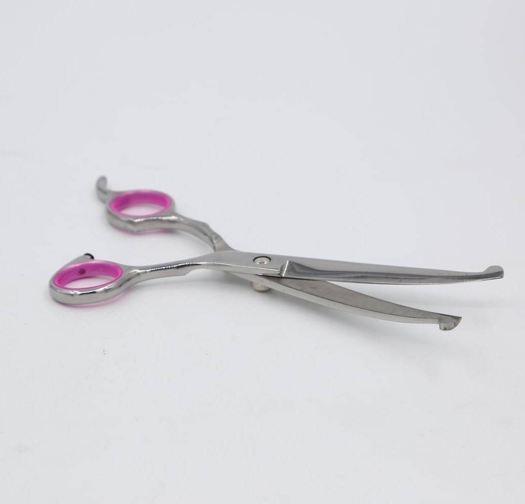 Paar silberner Haarschneidescheren mit rosa Fingerringen auf weißem Hintergrund.