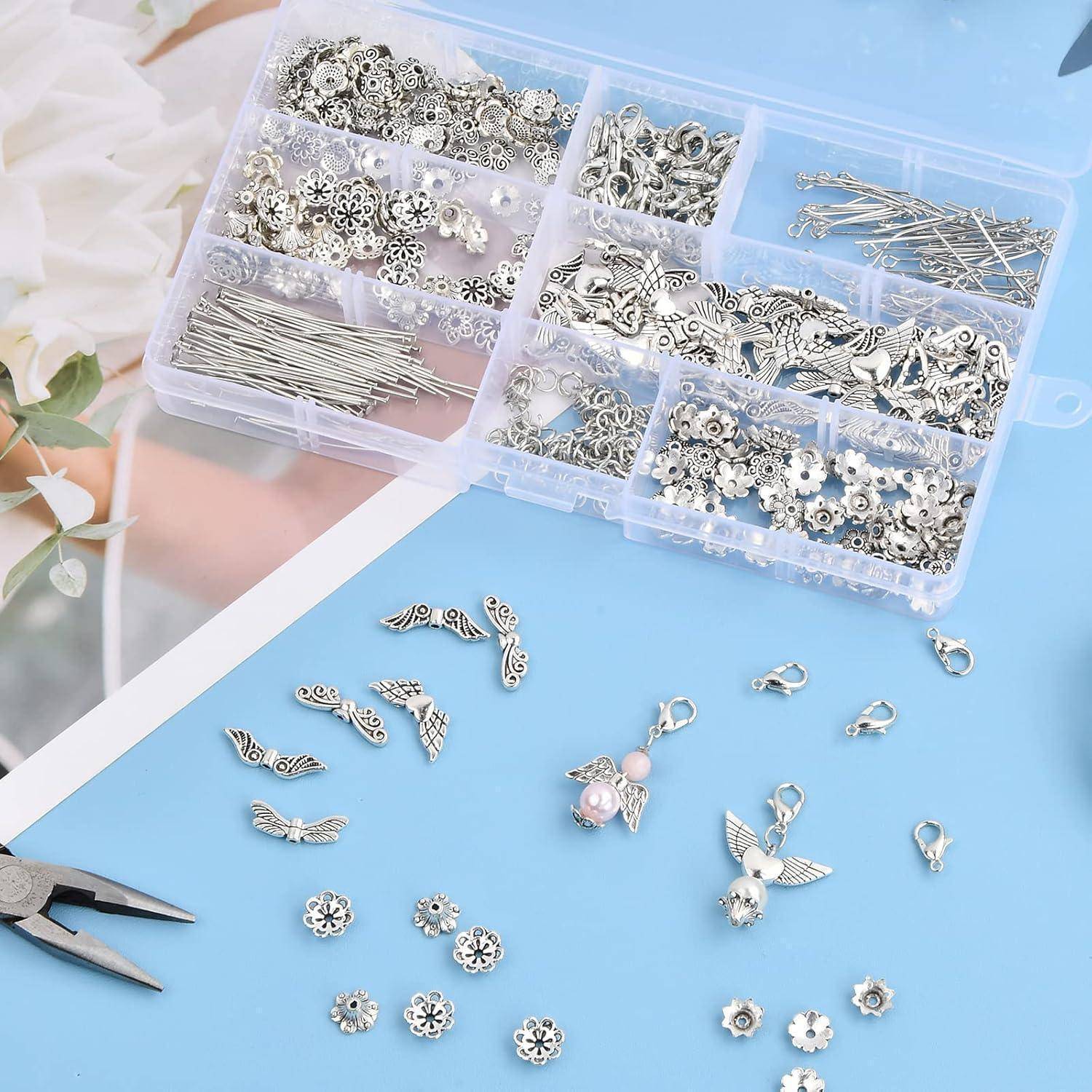 Ein Kunststoff-Organizer mit silberfarbenem Schmuckherstellungszubehör, Perlen und Beschlägen auf einer blauen Oberfläche, mit kleinen zusammengesetzten Anhängern und Werkzeugen in der Nähe.