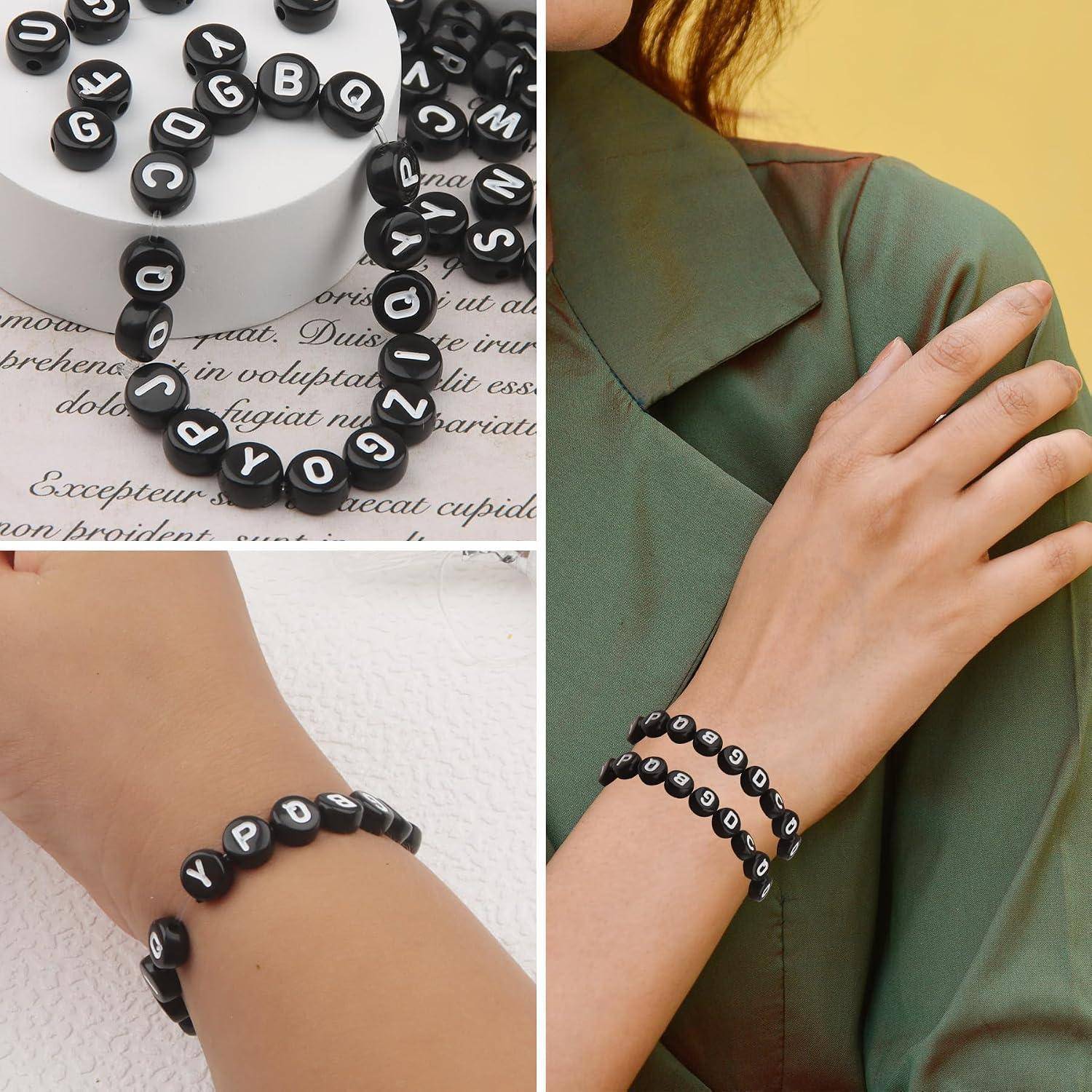 Schwarze Buchstaben-Perlenbänder, die romantische Wörter buchstabieren, werden als Halskette, Armband und getragen an Handgelenk und Arm gezeigt.